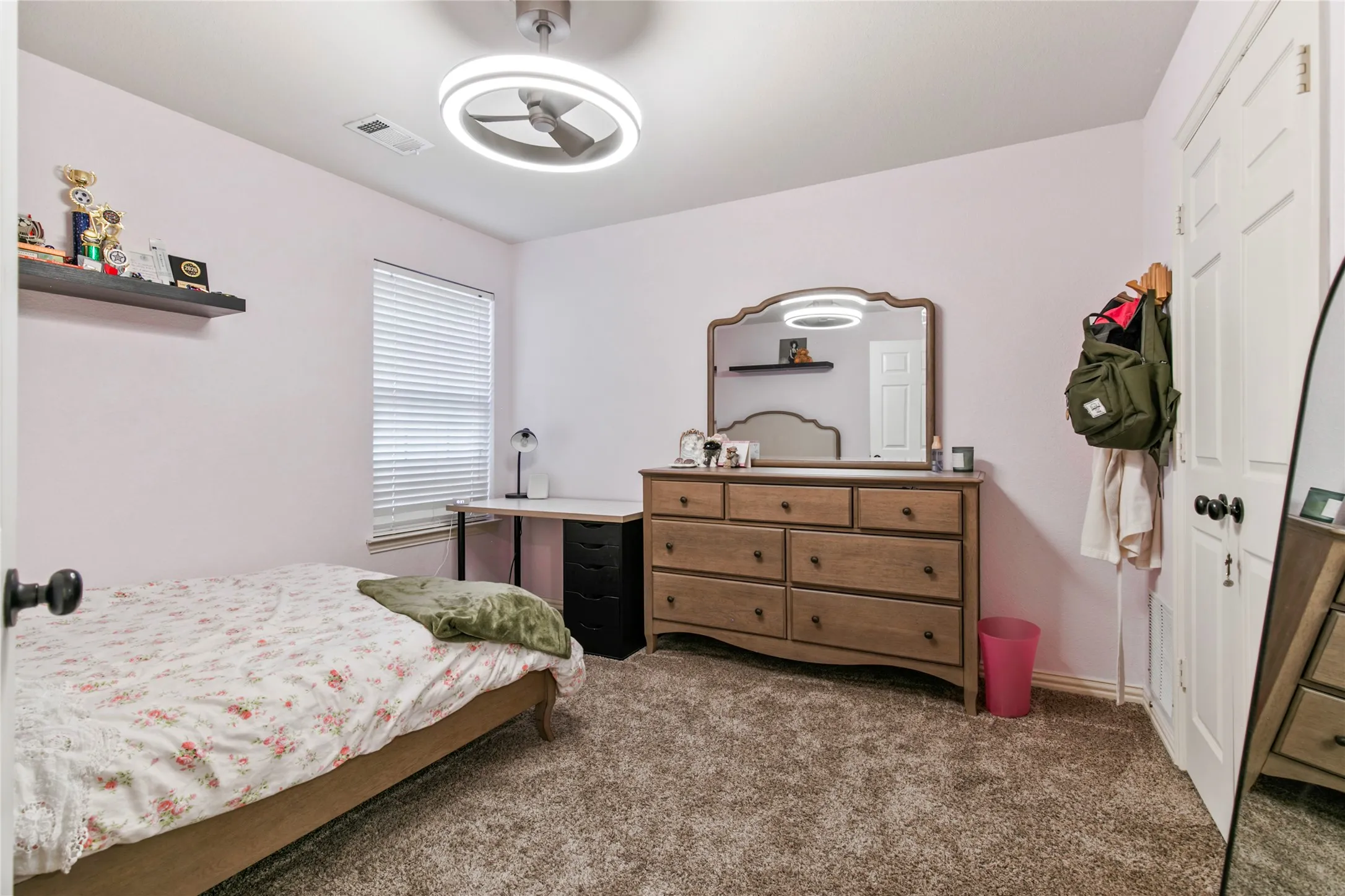 Interior room featuring light-colored walls and plush carpeting