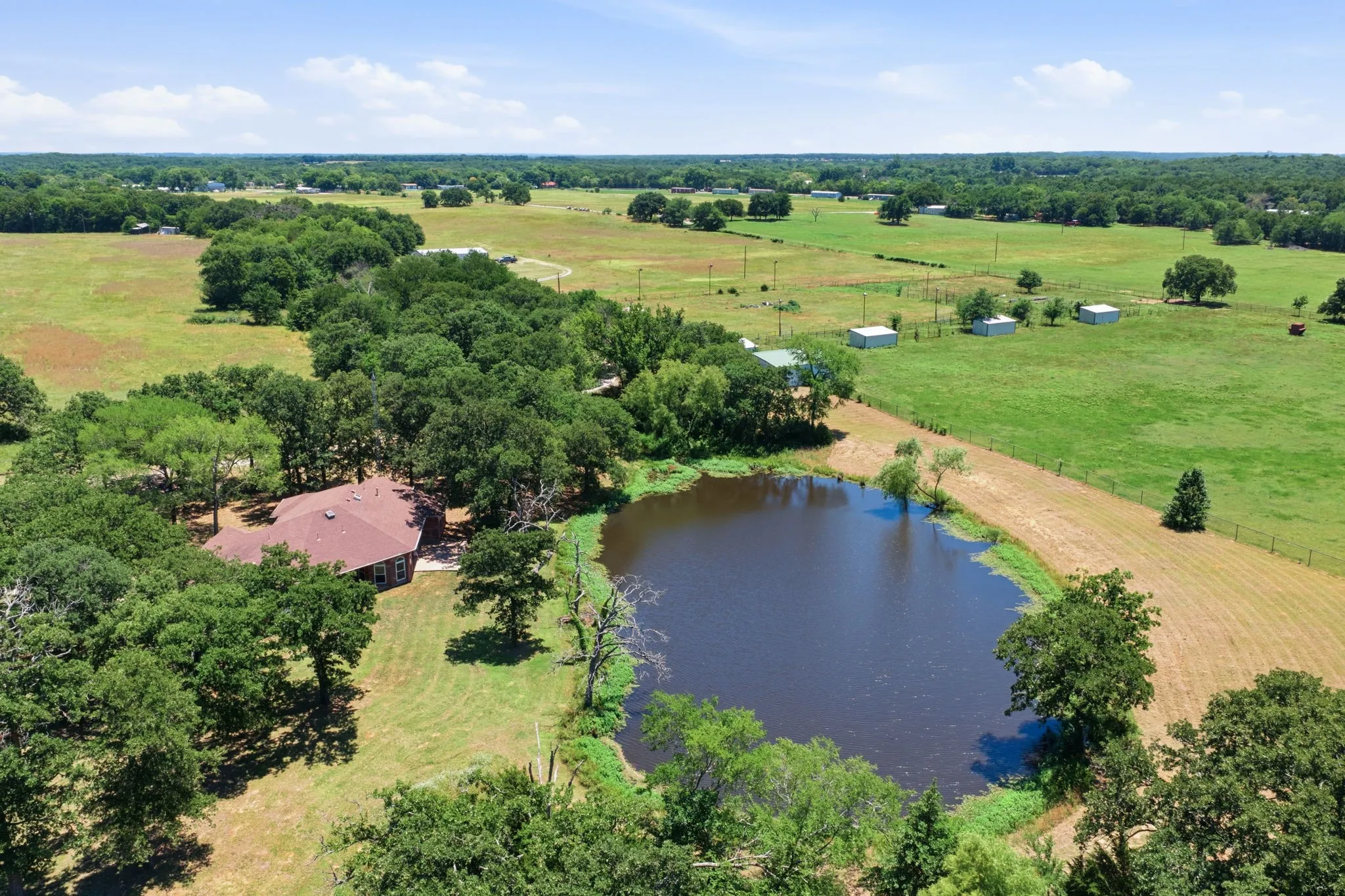 Aerial view from the pond looking toward the loafing shed and arena.