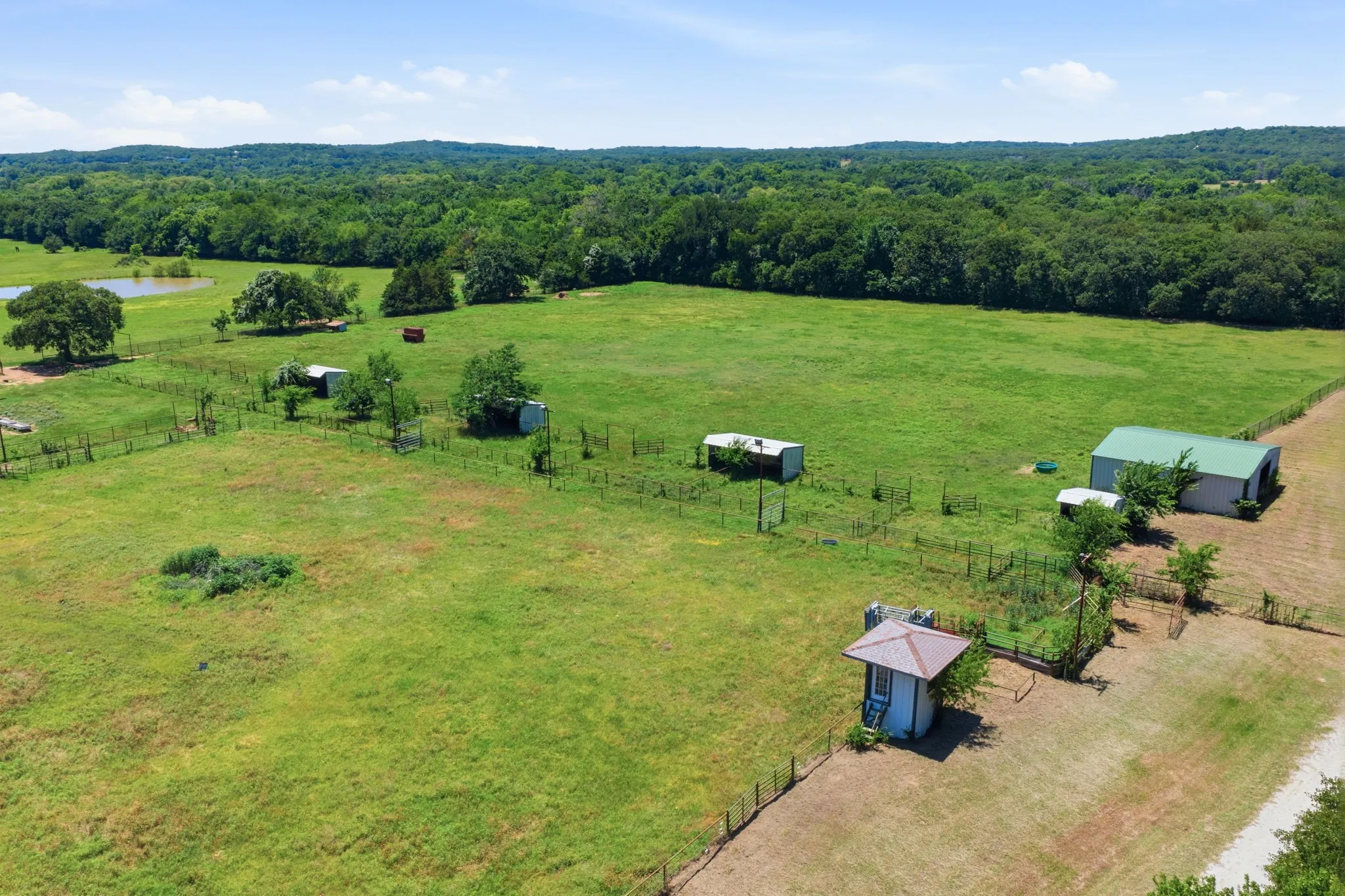 View of loafing sheds and barn.  This once usable announcers stand can be easily restored for all of your playdays!