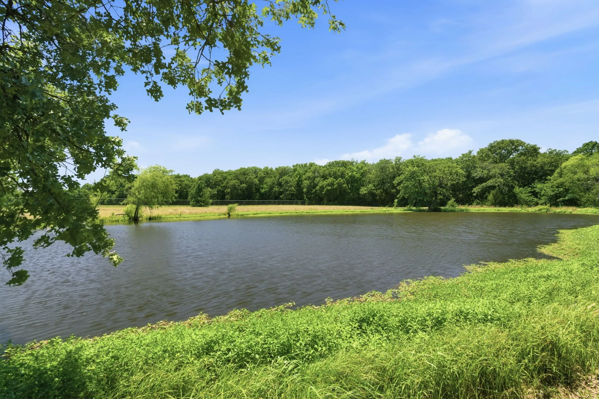 Pond is situated between the home and barns.