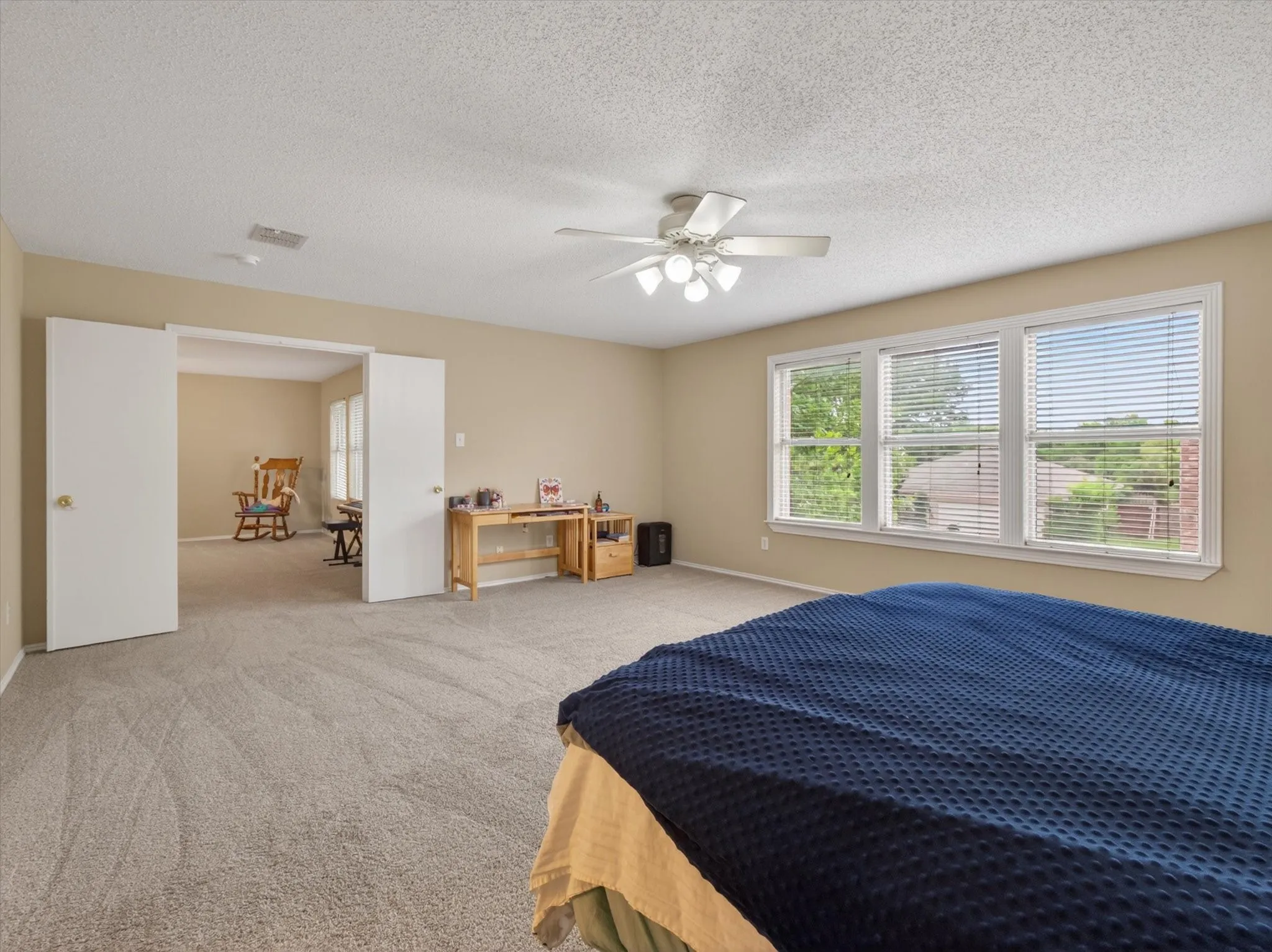 Spacious room featuring neutral carpeting and light-toned walls