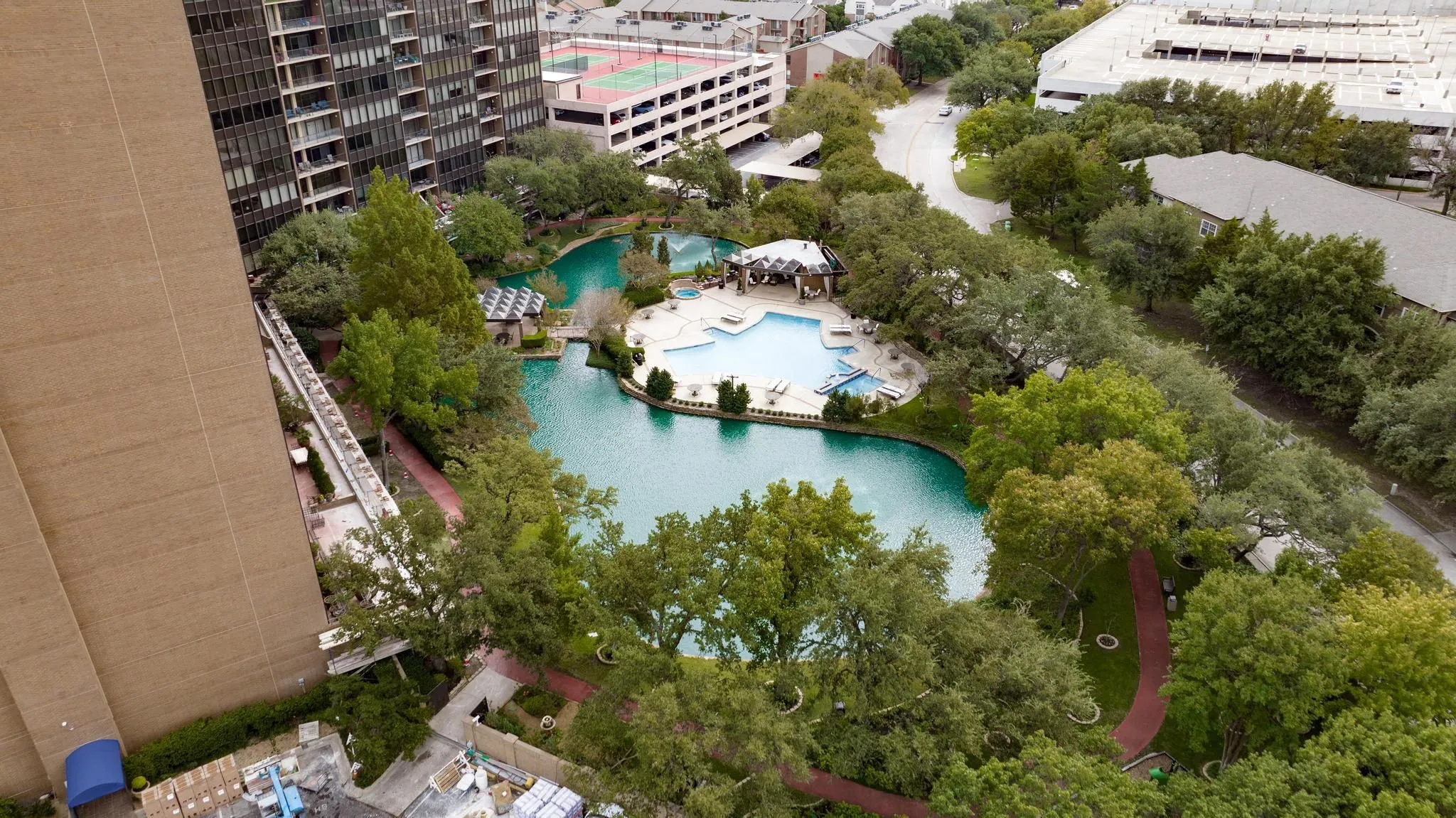 Expansive waterscape with a multi-level pool surrounded by mature trees