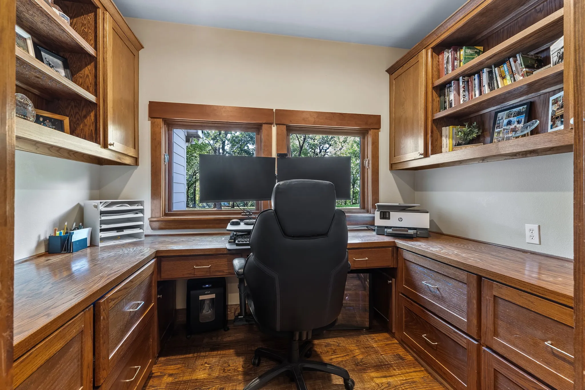 A home office is well appointed with custom built-ins and views!