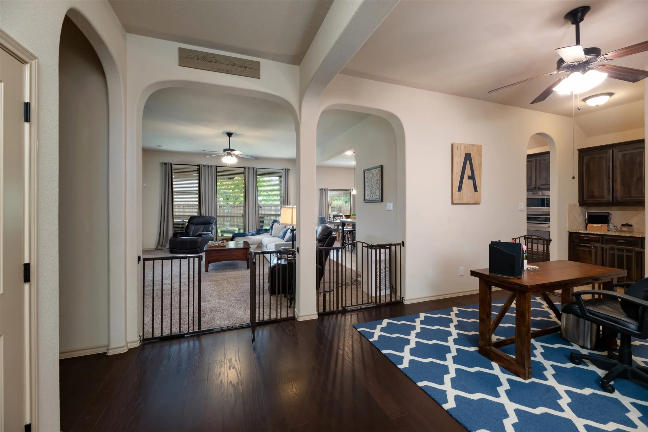 Front entry area of home looking into living area and flexible space.  Archways have removeable gates to open entryways.  Gates were used by owner for their pet.