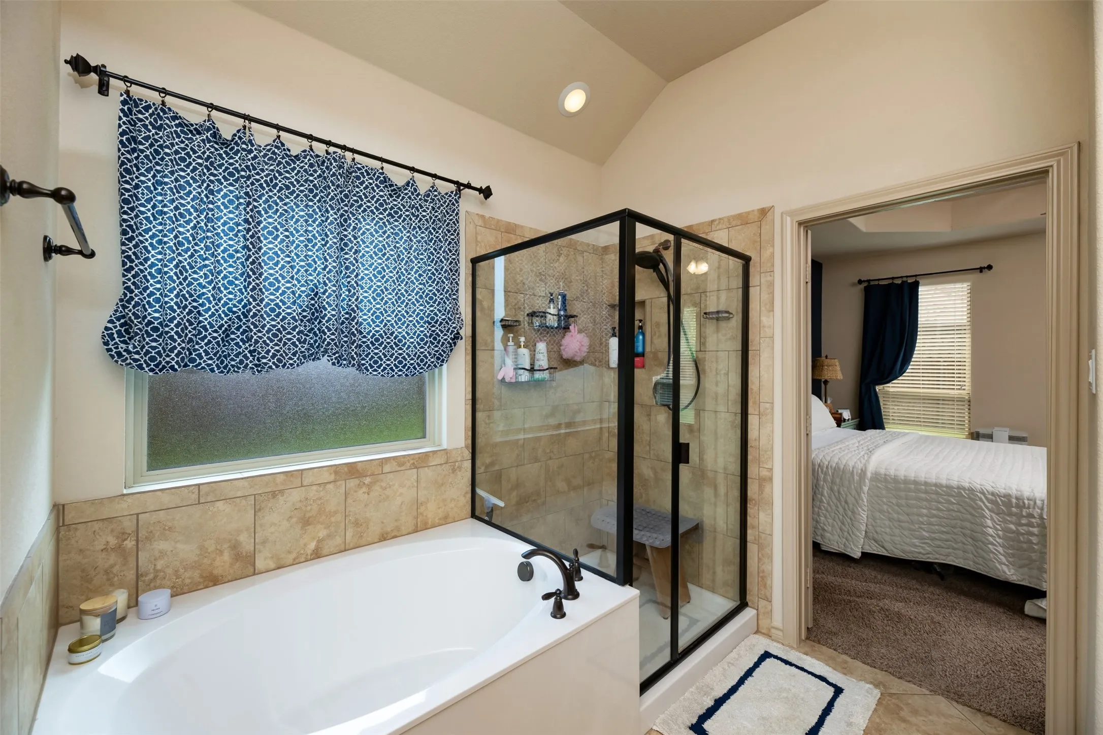Primary bedroom bath separate garden tub and glass wall shower