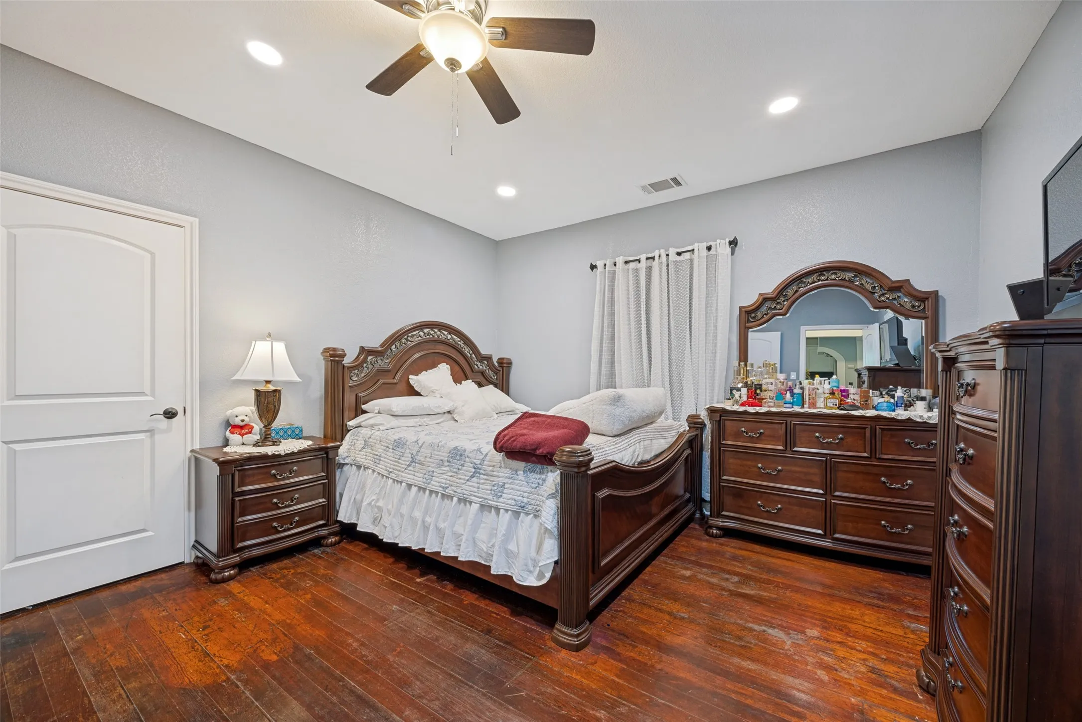 Recessed lighting illuminates the space, complemented by a ceiling fan with integrated light fixture