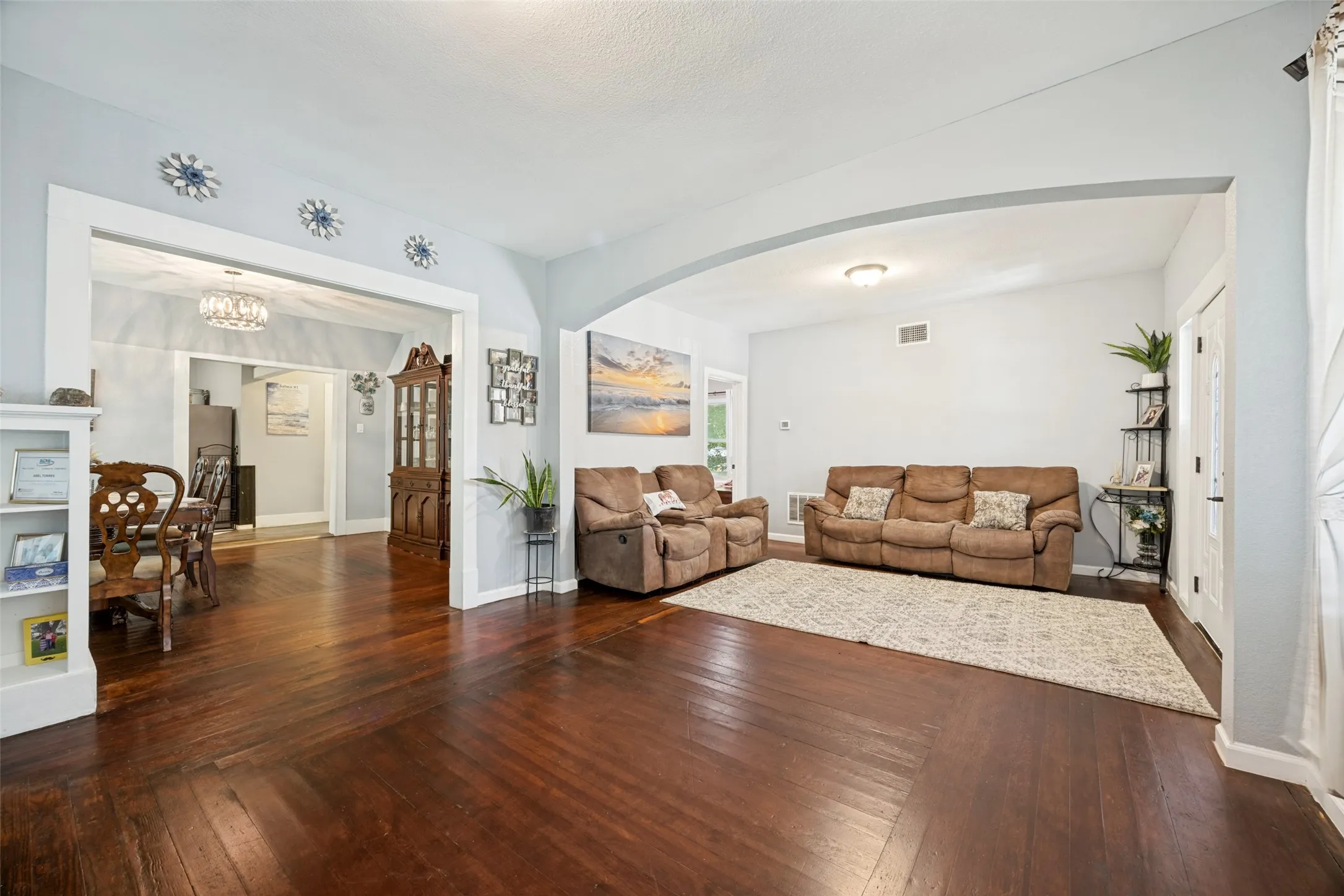 Rich wood-finish flooring extends throughout this expansive interior space