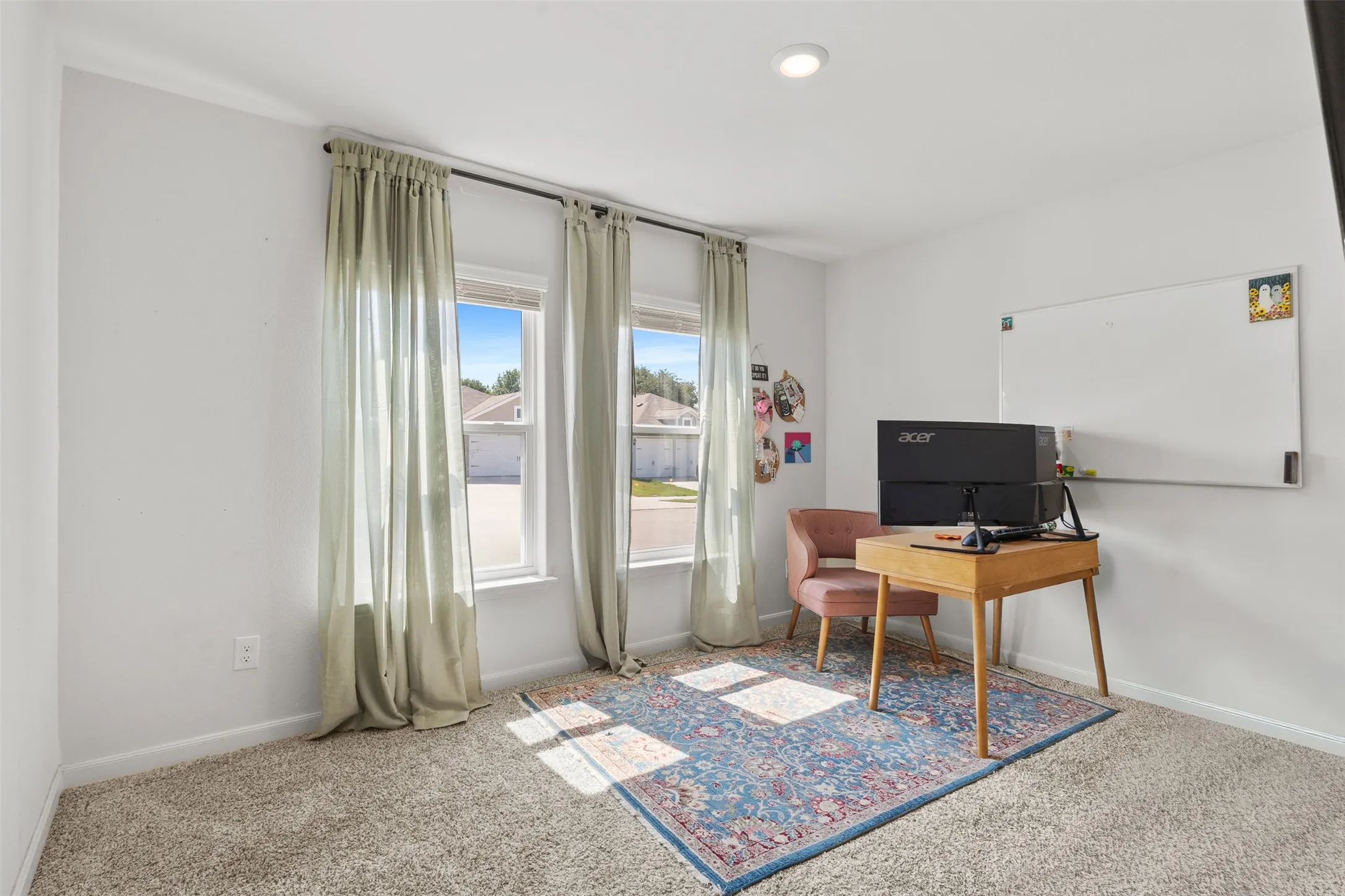 Light-filled room featuring two windows with curtain rods, neutral wall paint, recessed lighting, and carpet flooring
