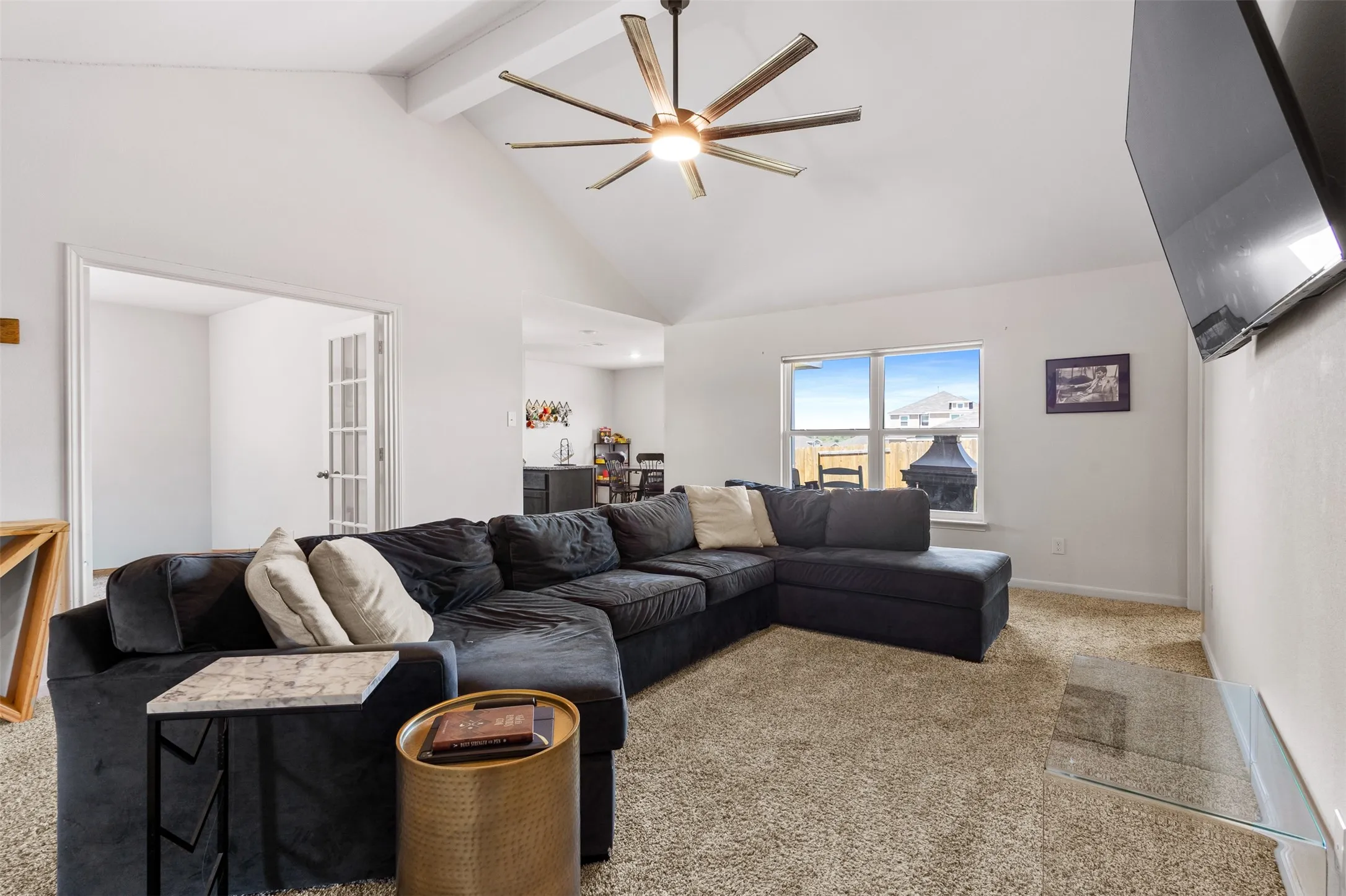 Vaulted ceiling featuring a contemporary ceiling fan with light fixture