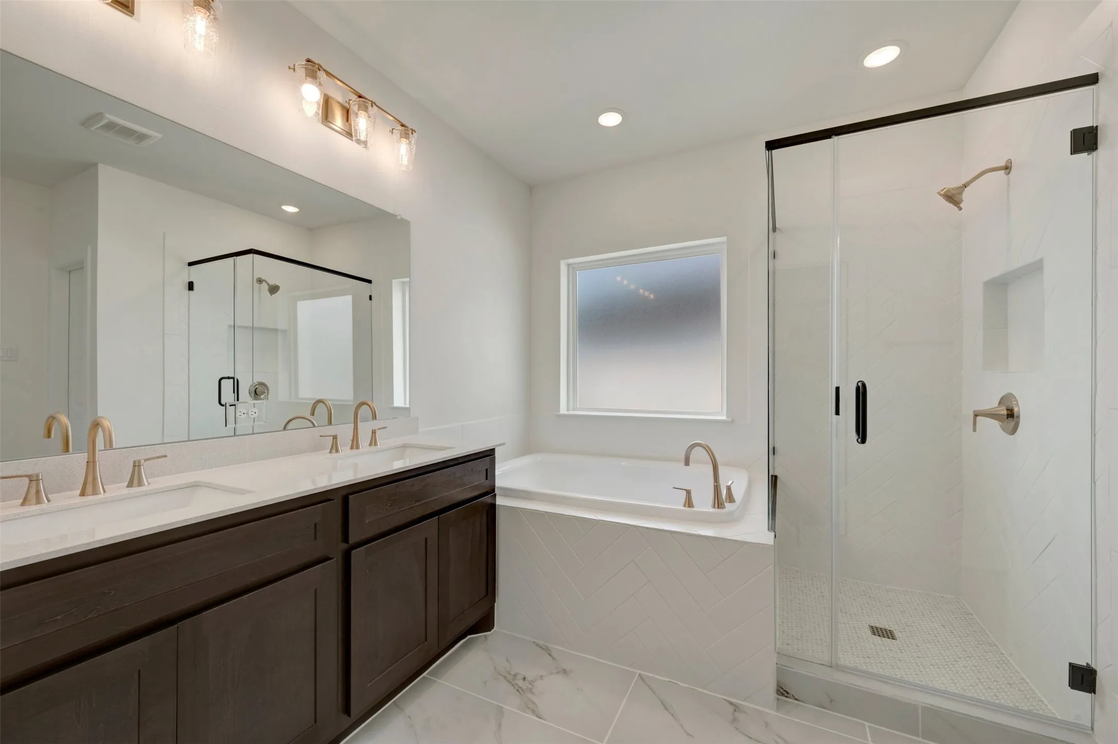 Dual vanity with dark wood-finish cabinetry and white countertops