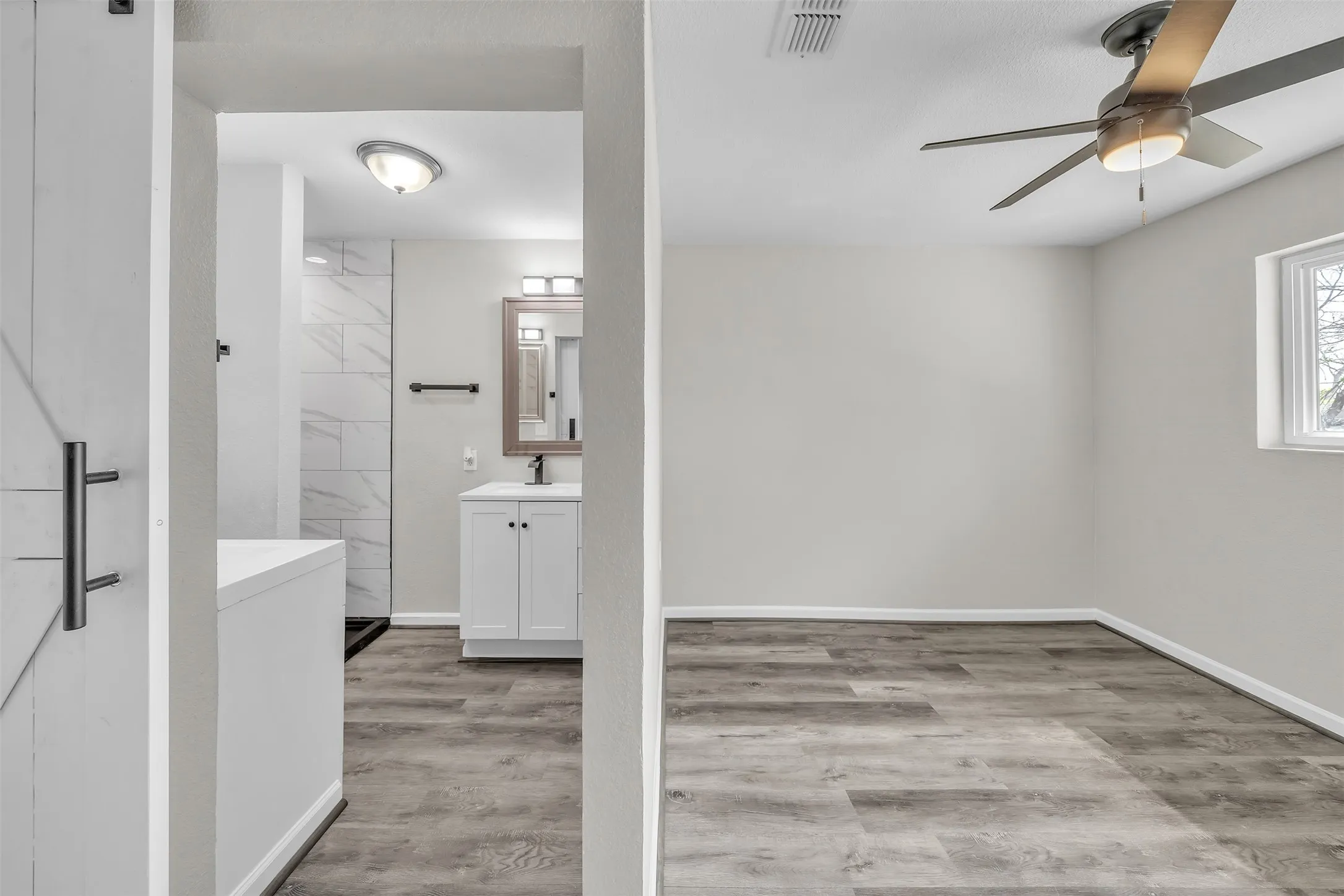 bonus bedroom with private ensuite bath, updated flooring and natural light.