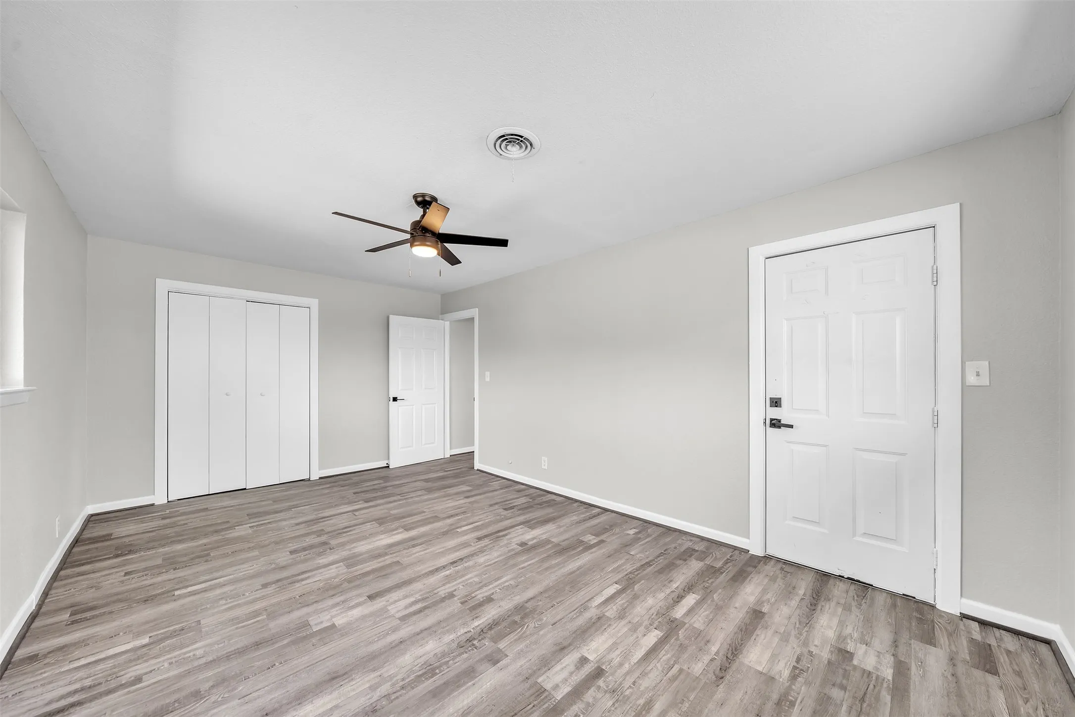 Spacious secondary bedroom with updated flooring, natural light and generous room for furnishings.
