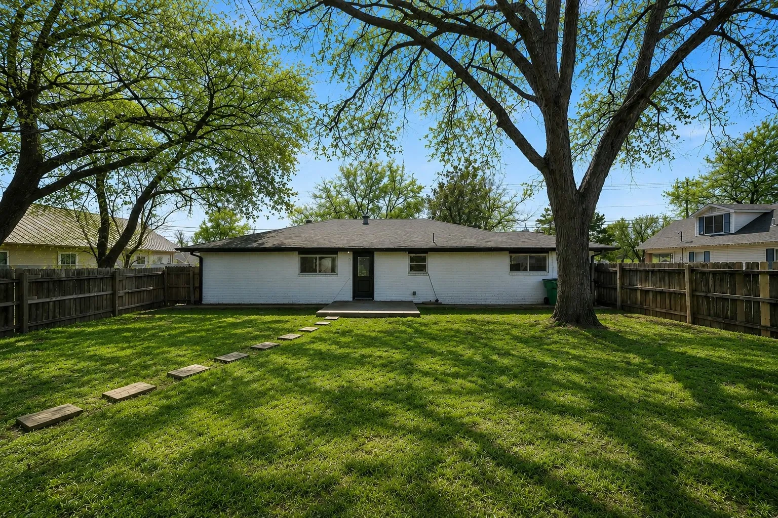 Tree-lined backyard provides a private setting with plenty of usable outdoor space.
