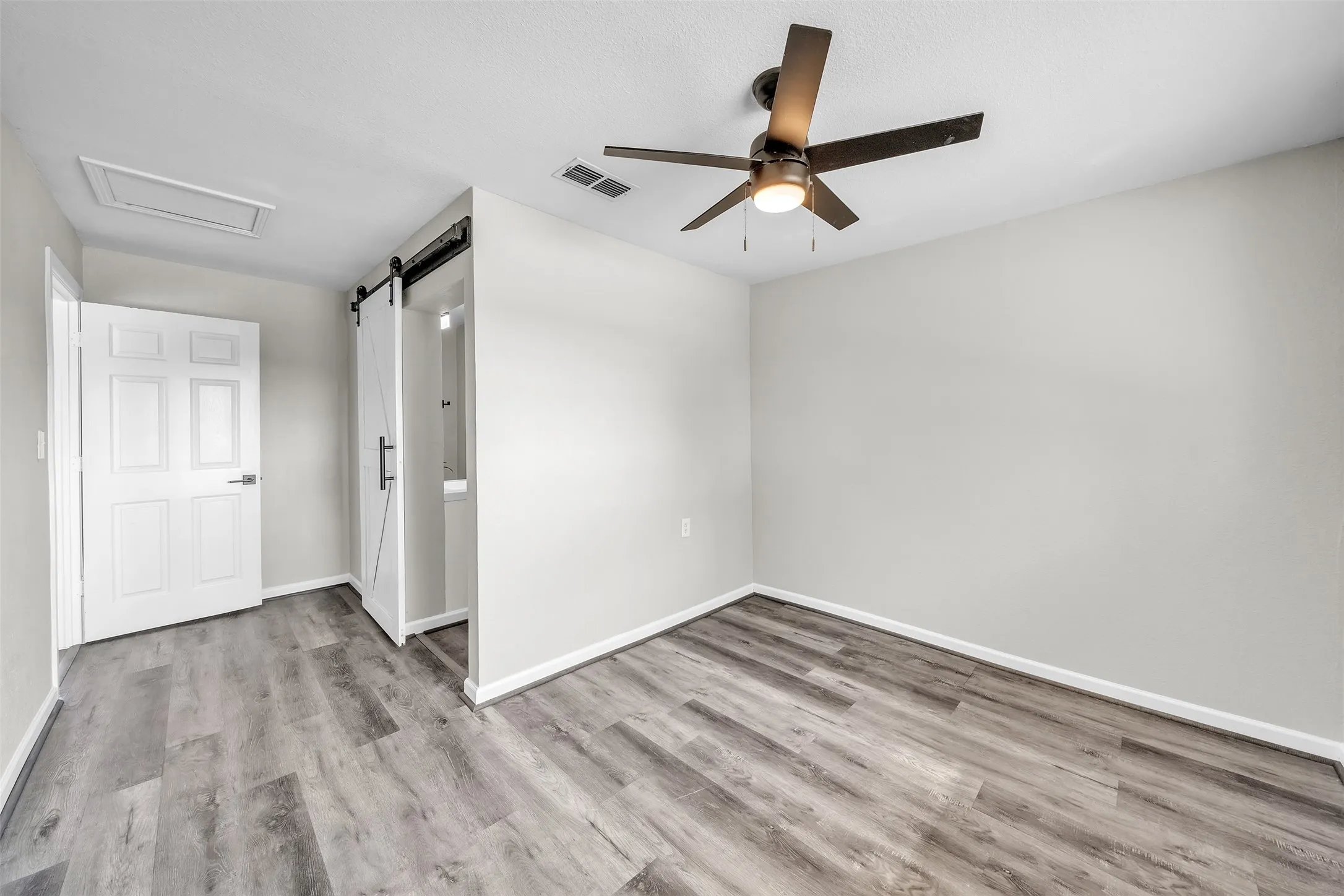 Spacious bedroom with natural light and flexible furniture placement.