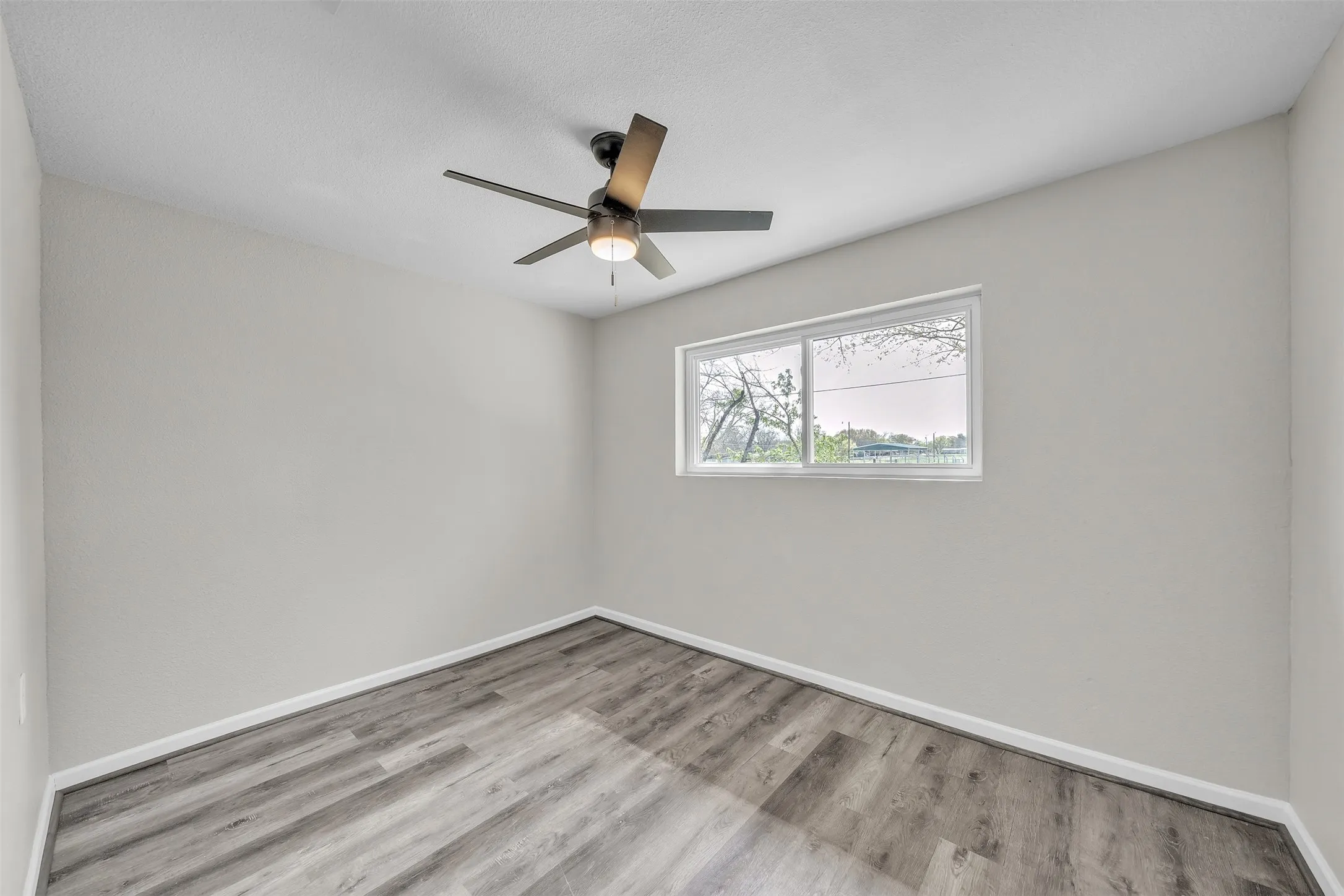 Comfortable secondary bedroom with natural light and a functional layout.
