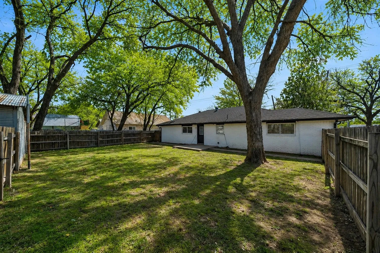 Large backyard offers ample space for entertaining, pets, play or future outdoor additions.