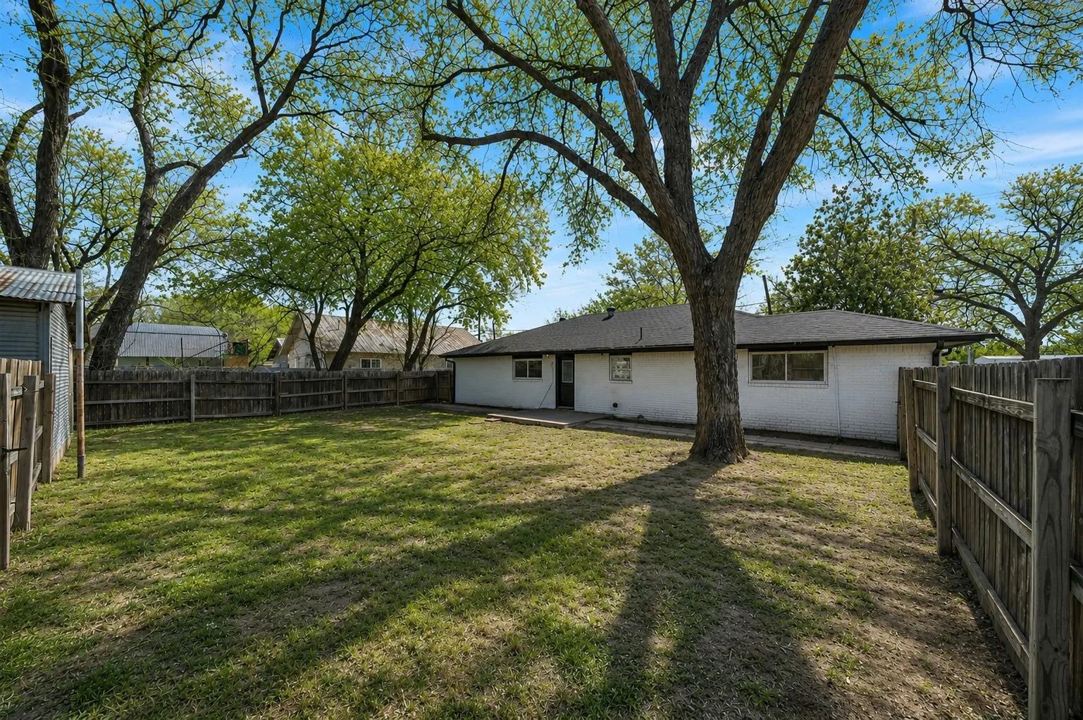 Situated on an oversized corner lot with mature trees and expansive outdoor space.