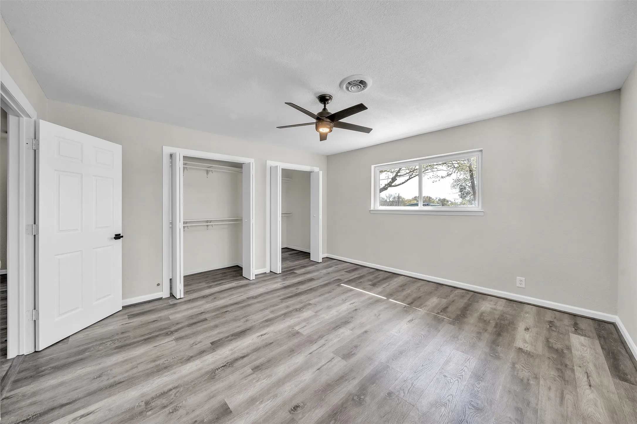 1. Light-filled primary bedroom with a comfortable layout and direct access to the bathroom.