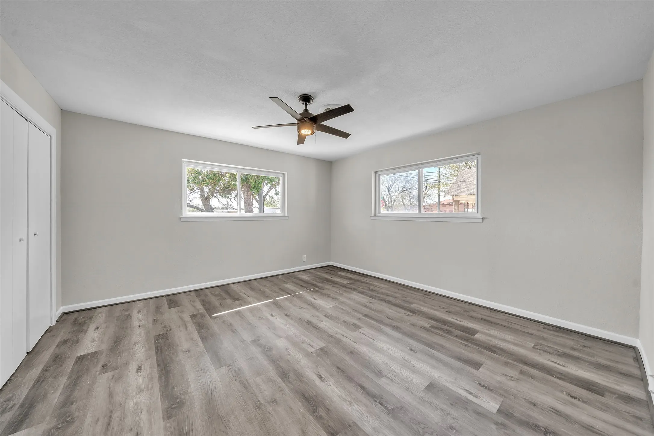 Spacious primary bedroom with natural light and generous room for furnishings.