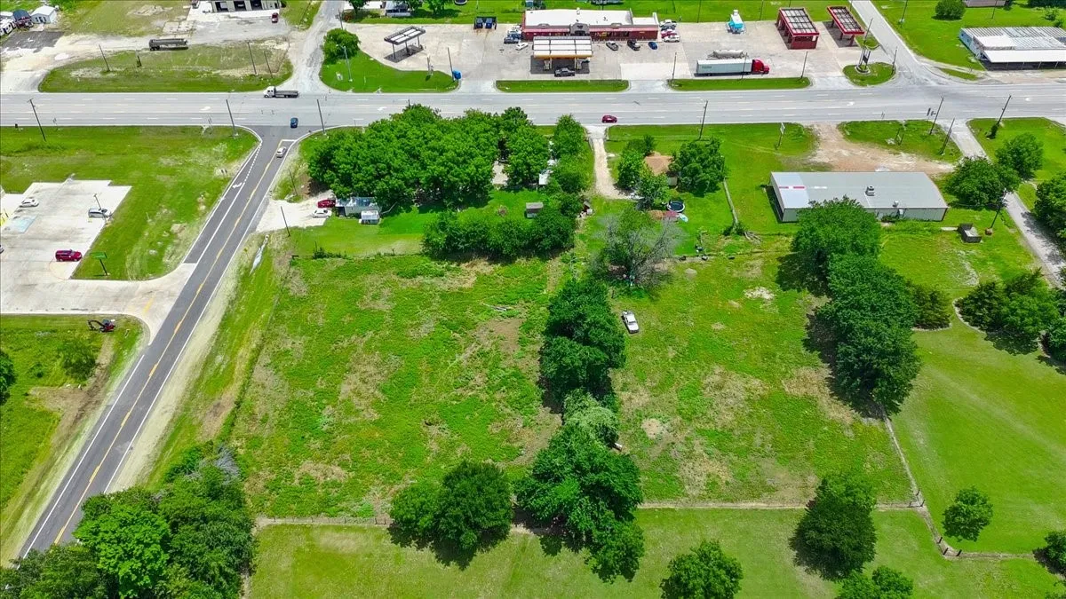 Expansive undeveloped lot featuring substantial green space and mature trees