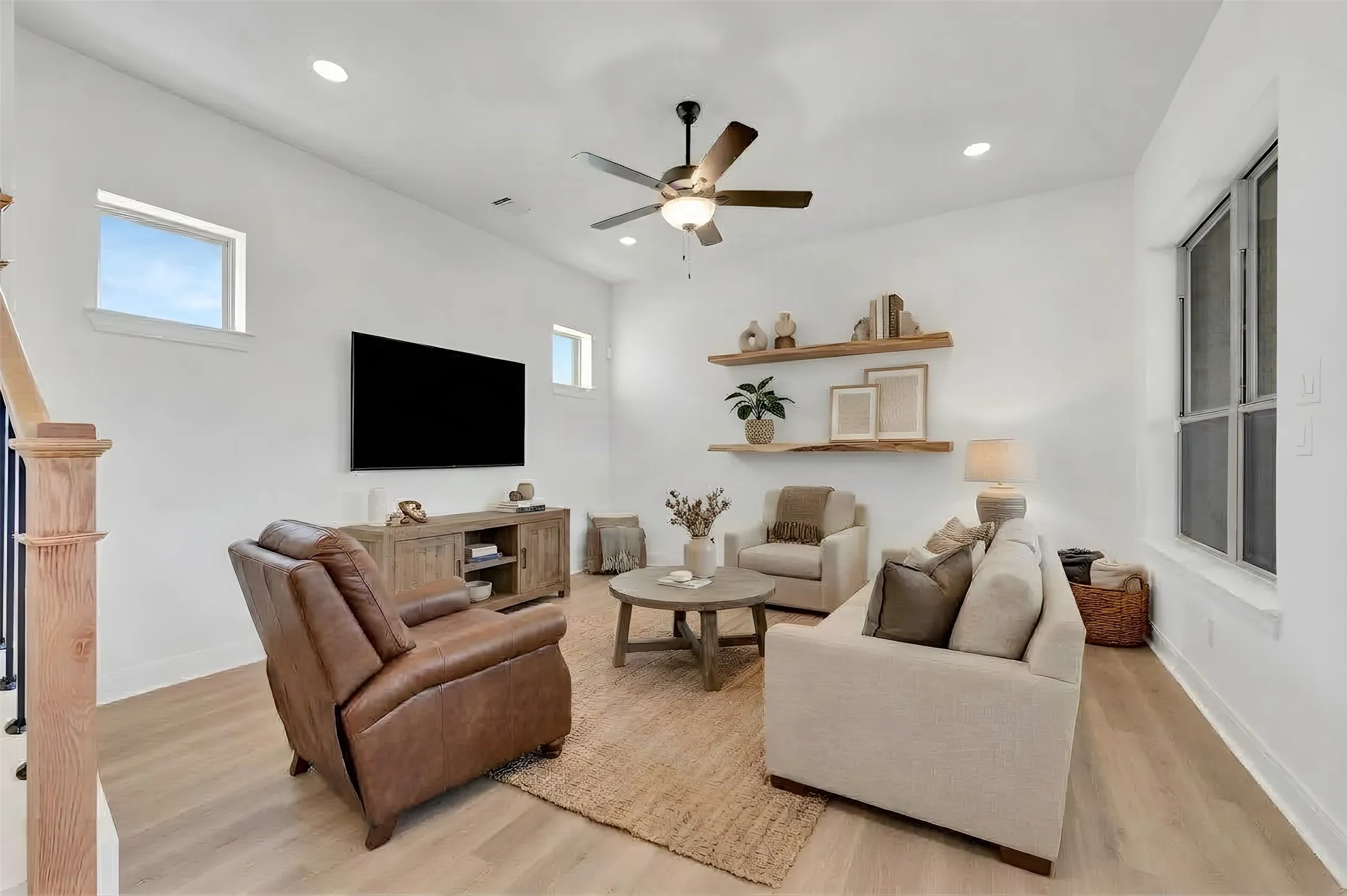 Recessed lighting, wood-finish flooring, ceiling fan, built-in shelving, and multiple windows