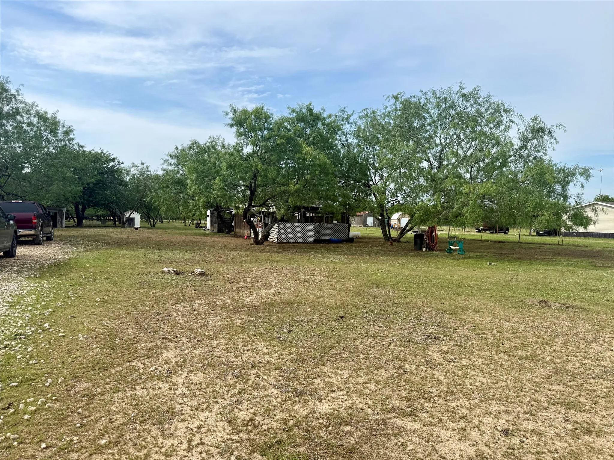 Extensive property with mature trees and a gravel driveway