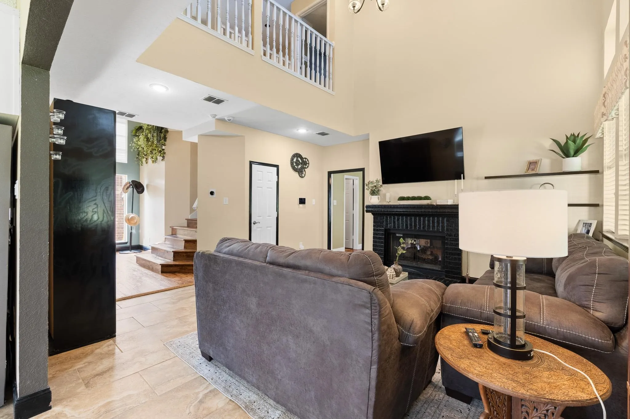Family room featuring a black mantel fireplace with a television mount, light-toned wall paint, and recessed lighting