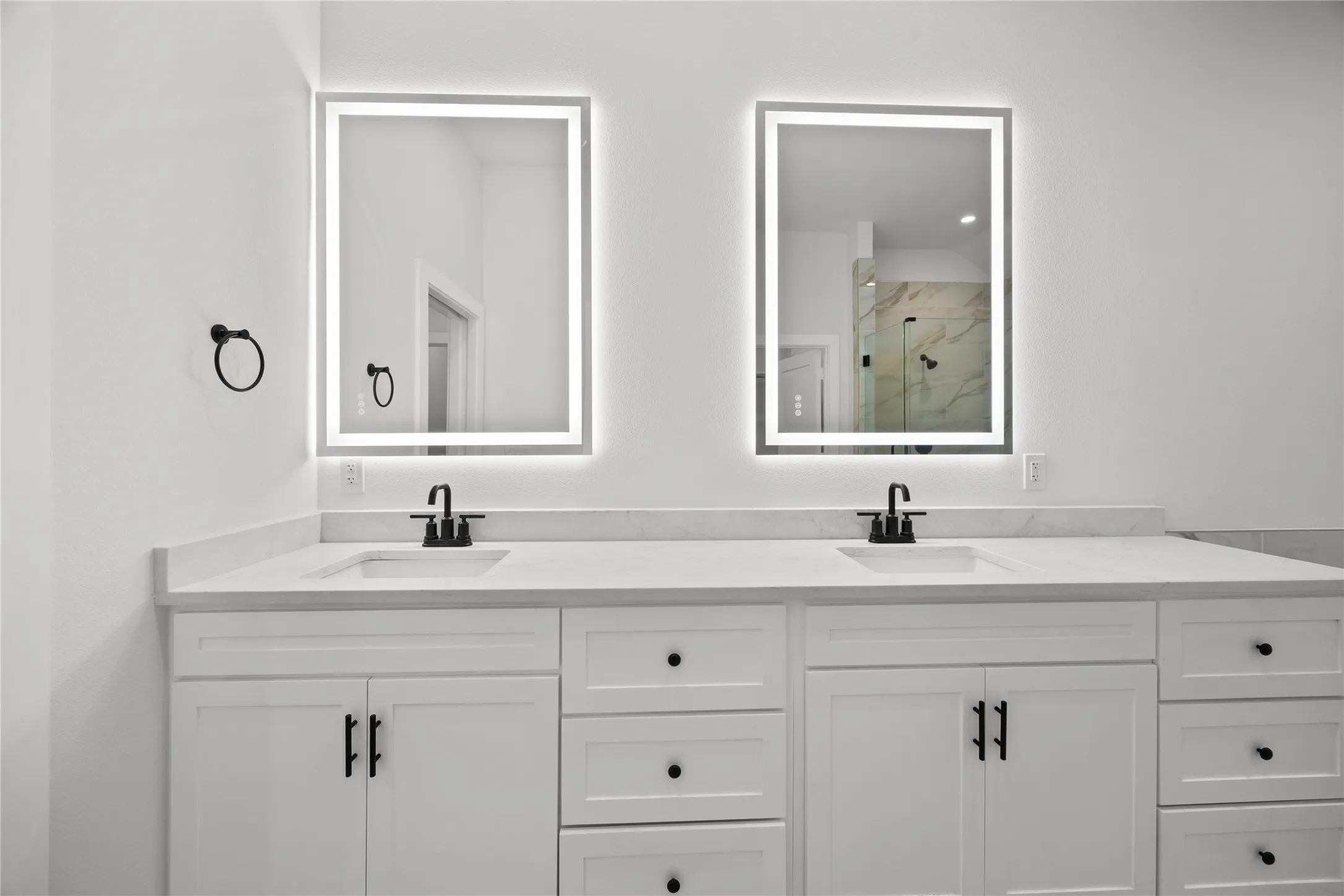 Dual vanity with rectangular undermount sinks, stone countertops, and matte black fixtures