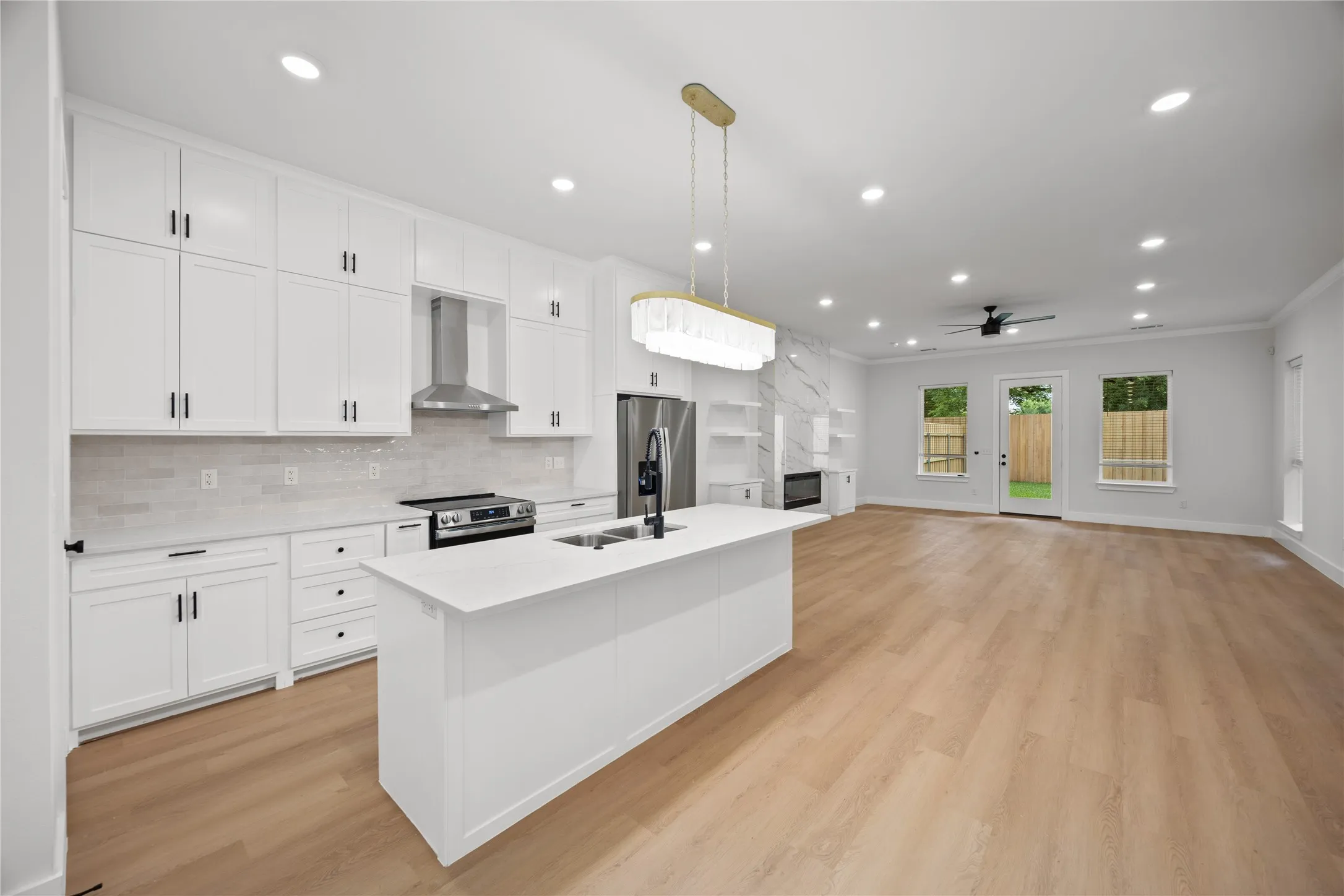 Open-concept living space with light wood-finish flooring