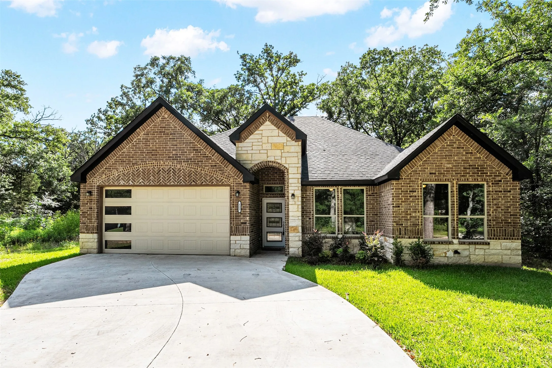 Front of house with 2 car garage and driveway