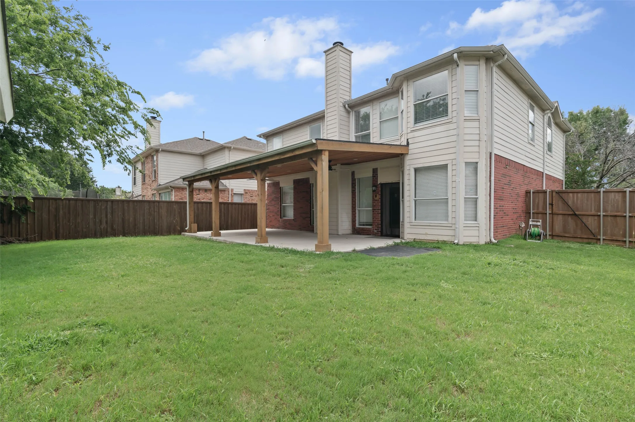 Large backyard with covered patio and shed