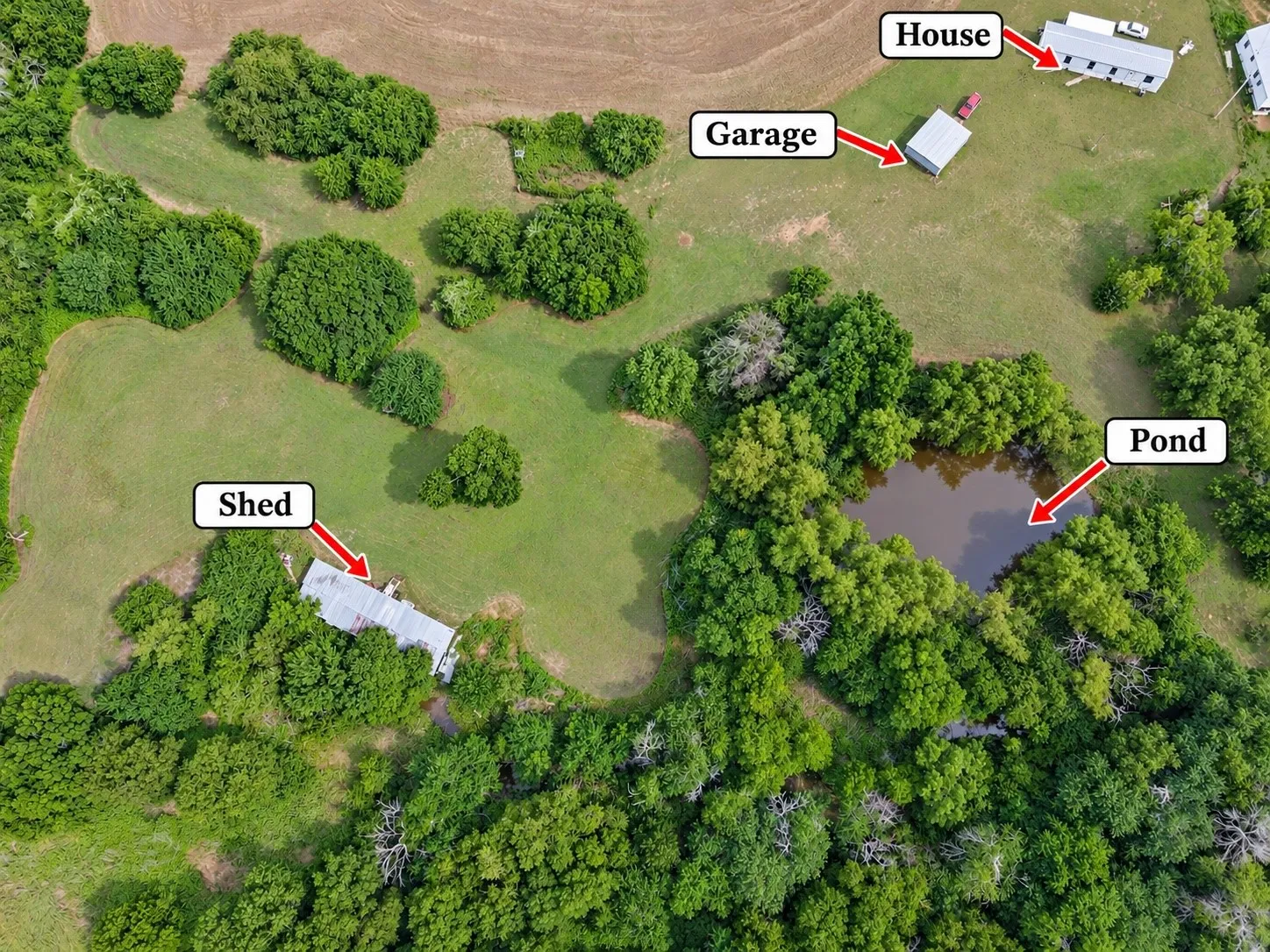 Expansive property featuring a detached house, garage, shed, and natural pond