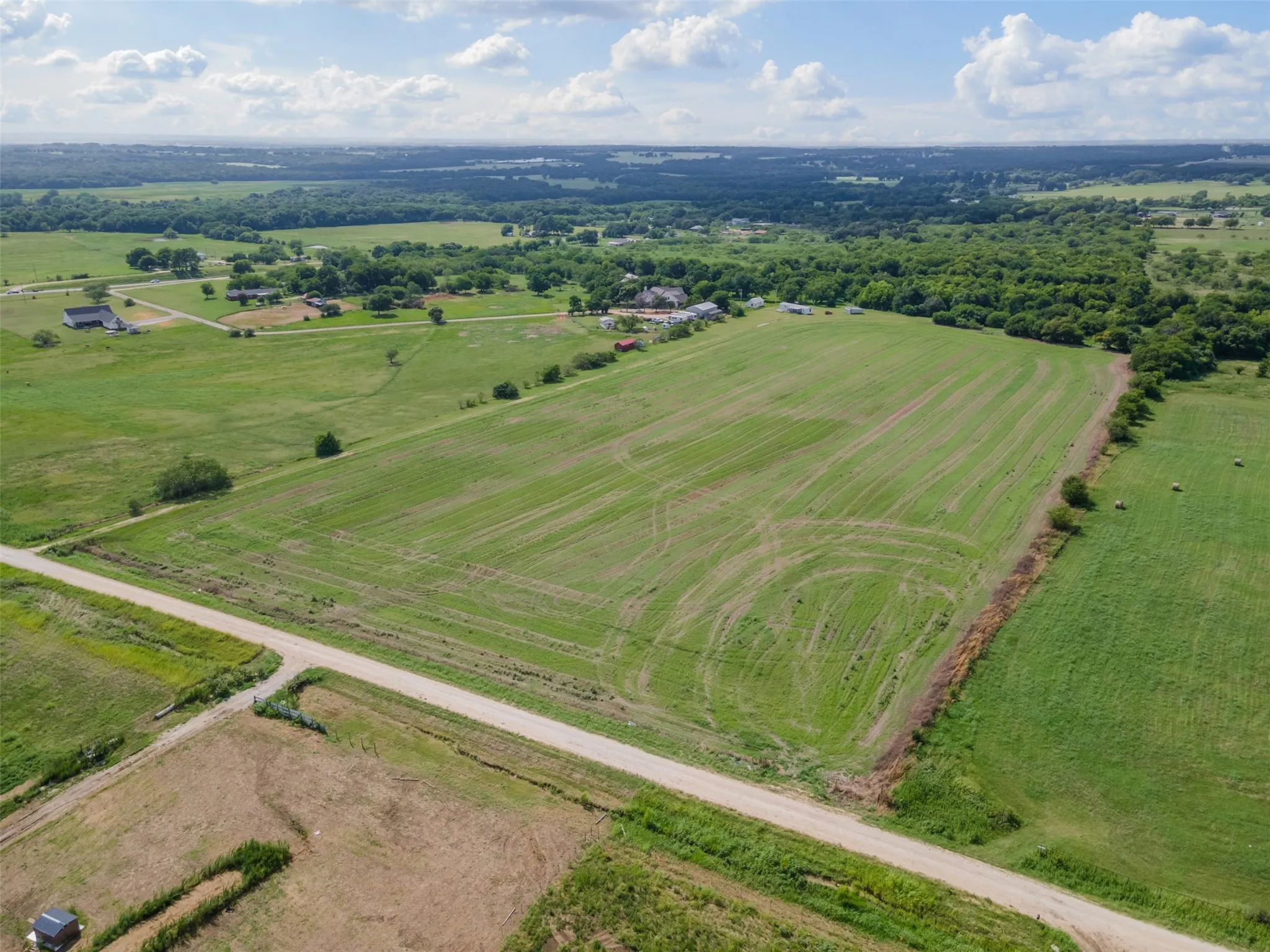 Expansive open fields featuring cultivated land and natural greenery