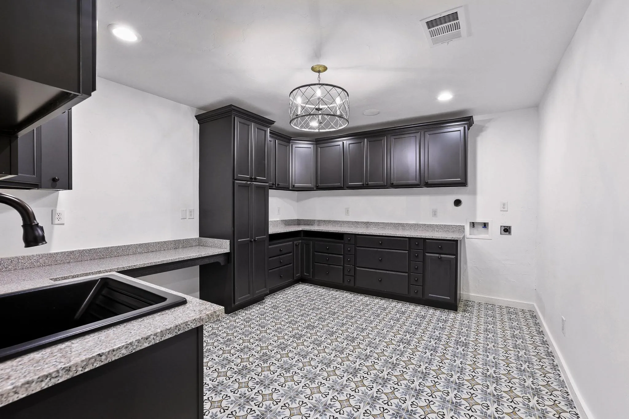Large laundry room with sink and cabinet storage.