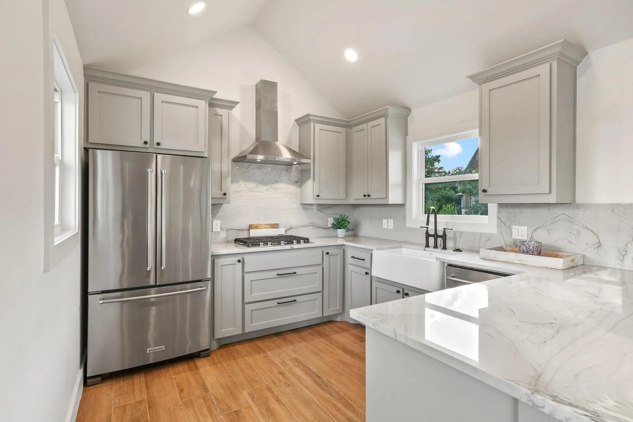 Pool house kitchen with stainless appliances and counter space.