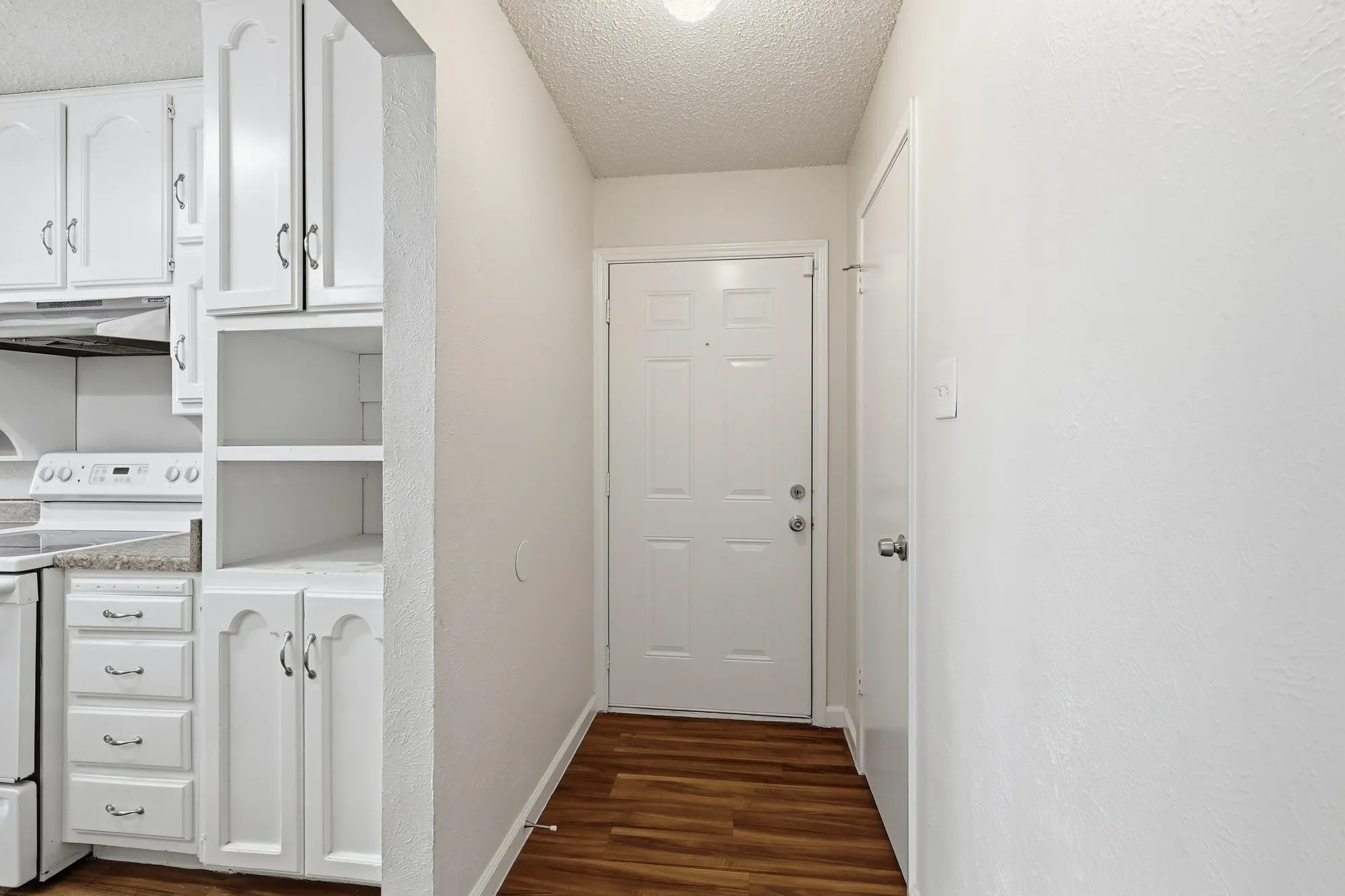 Inviting front foyer offering easy access to the kitchen and additional built-in storage for everyday convenience.
