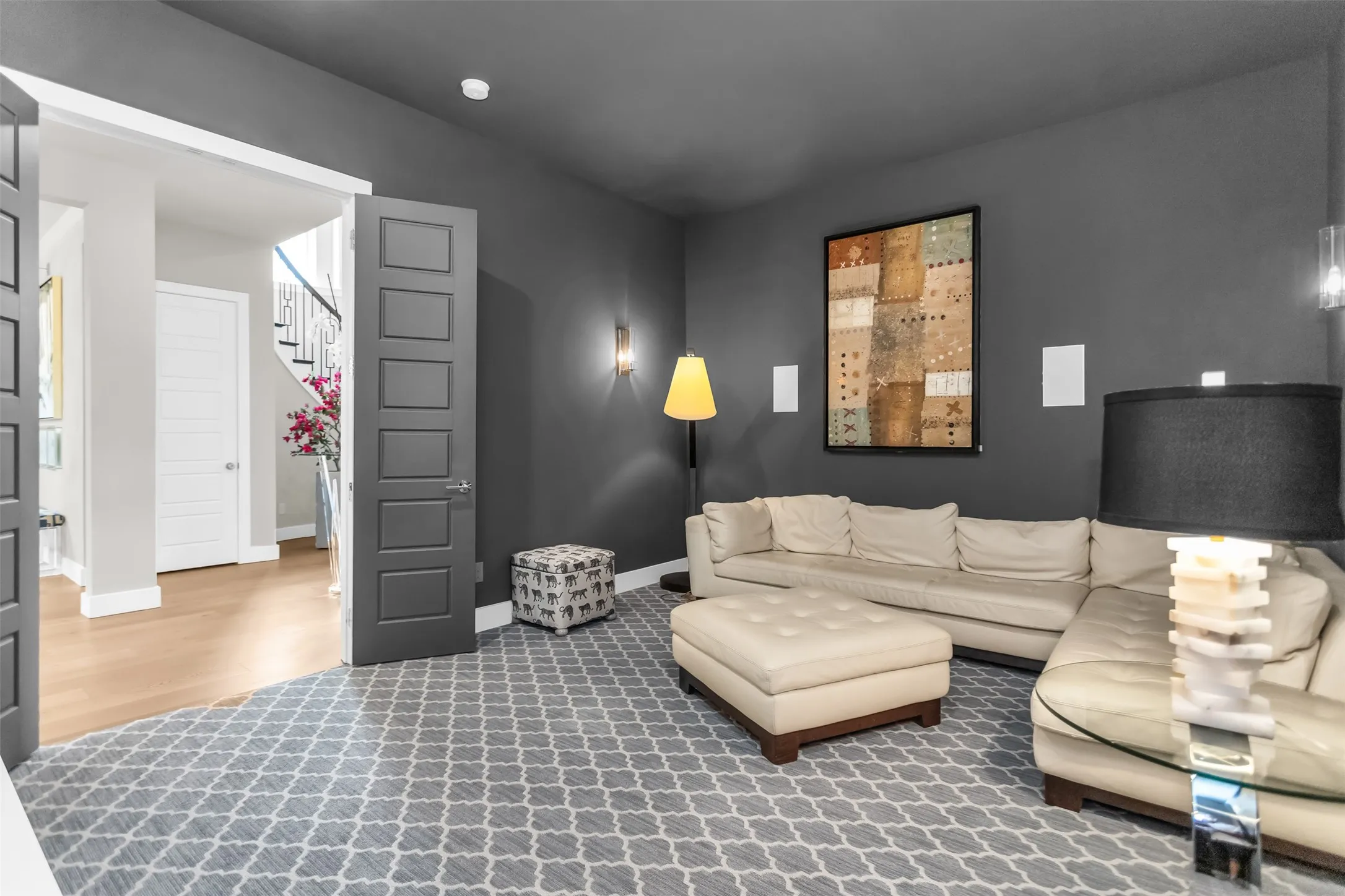 Room with dark gray walls and patterned carpet flooring