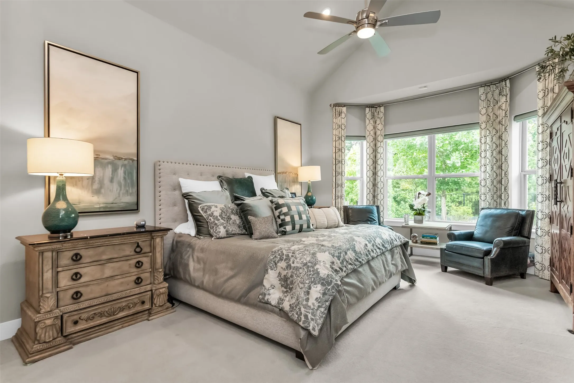 Spacious room featuring a vaulted ceiling and a ceiling fan with integrated lighting