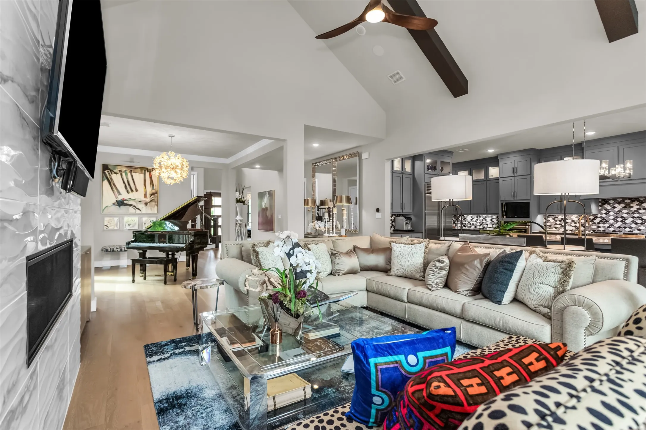 Vaulted ceiling with exposed wood beams and a ceiling fan
