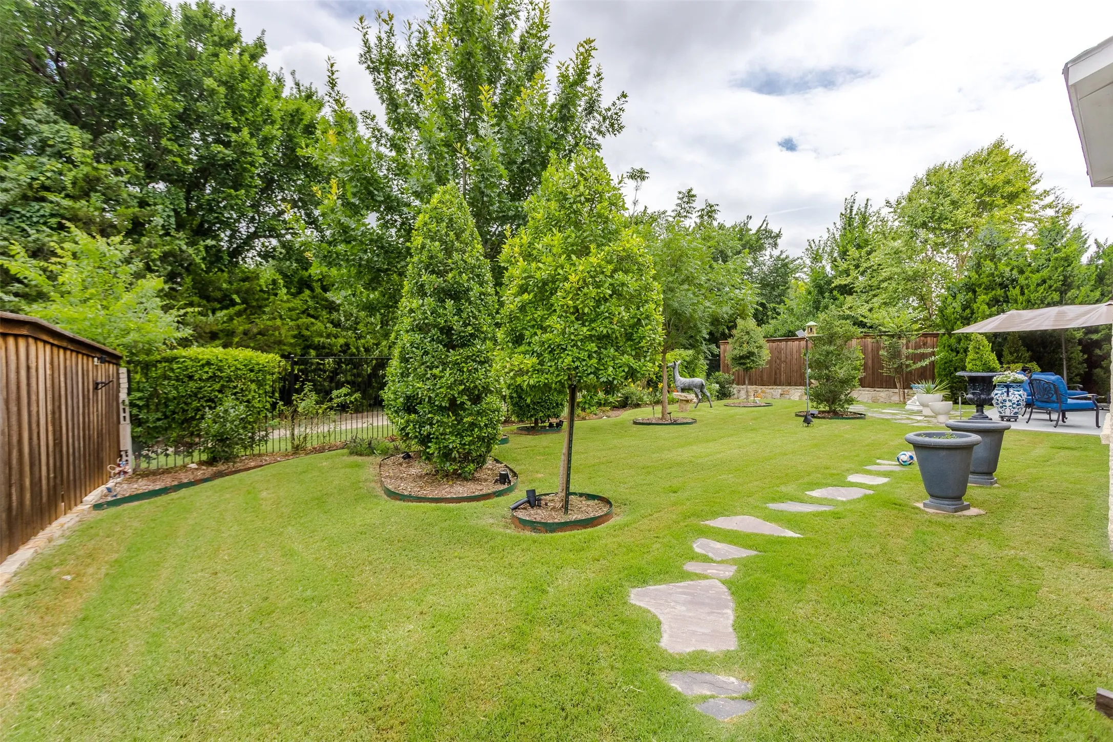 Expansive green lawn with a stone pathway