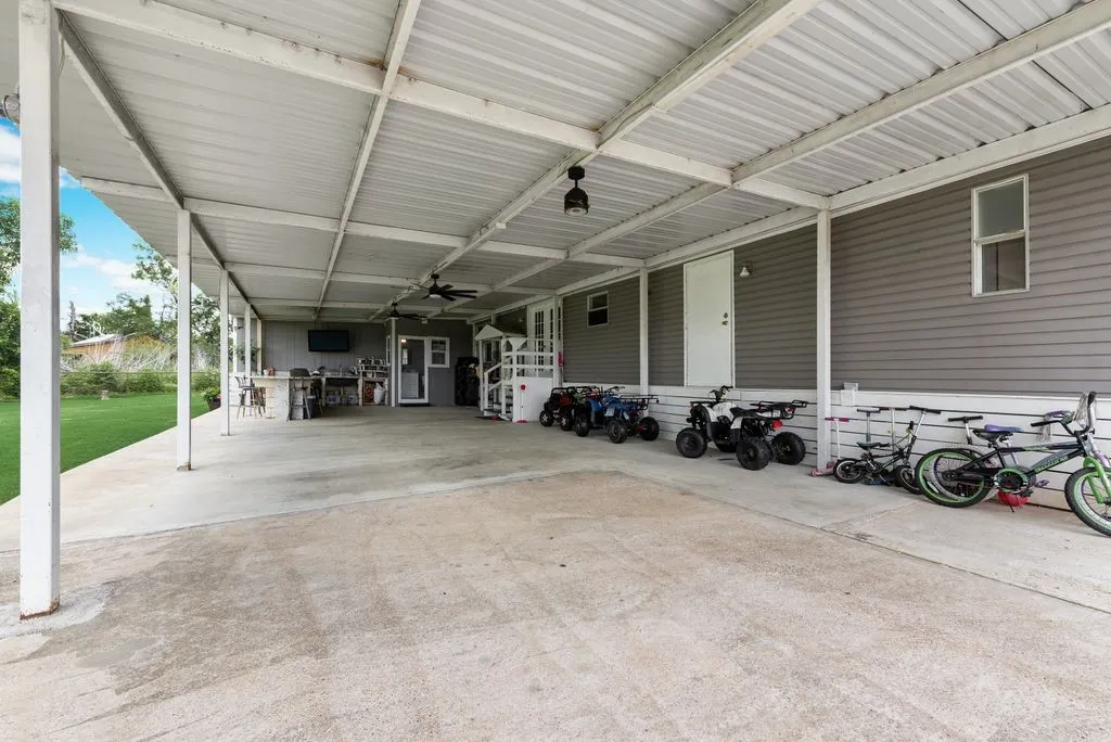 Extended 2 car carport and outdoor kitchen is the perfect place to host!