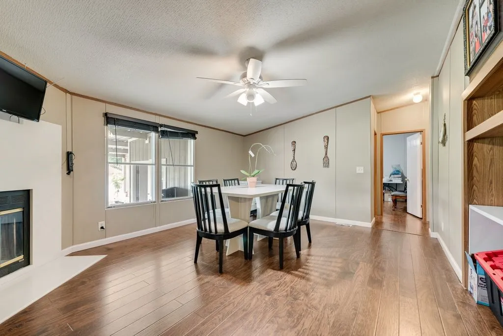 The formal dining room features a fireplace surrounded in beautiful granite