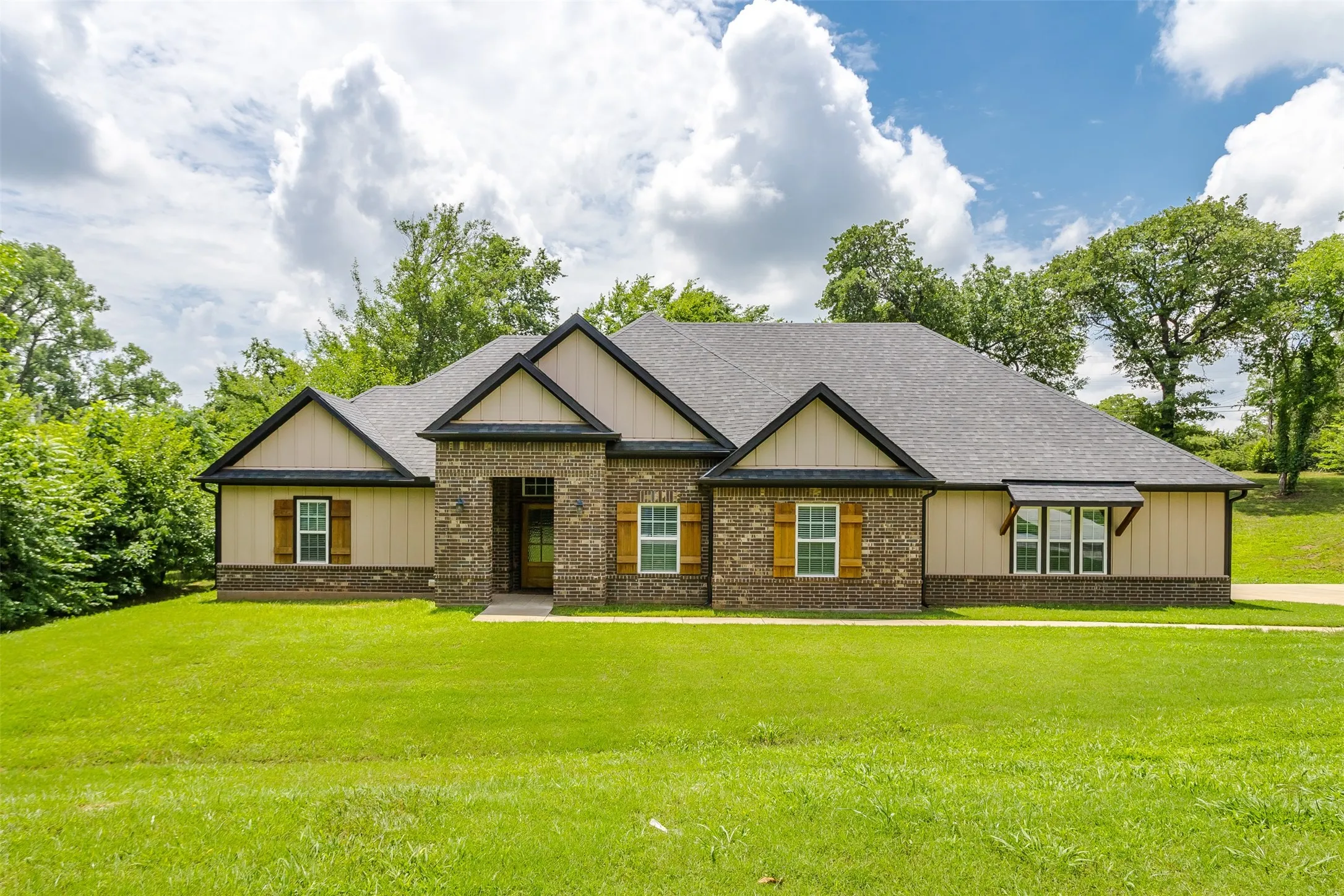 Brick and siding exterior with dark trim accents