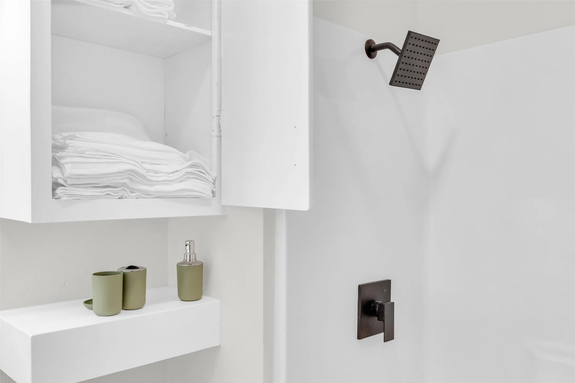 Shower stall featuring a square rain shower head and a single-handle control, both in a matte dark finish