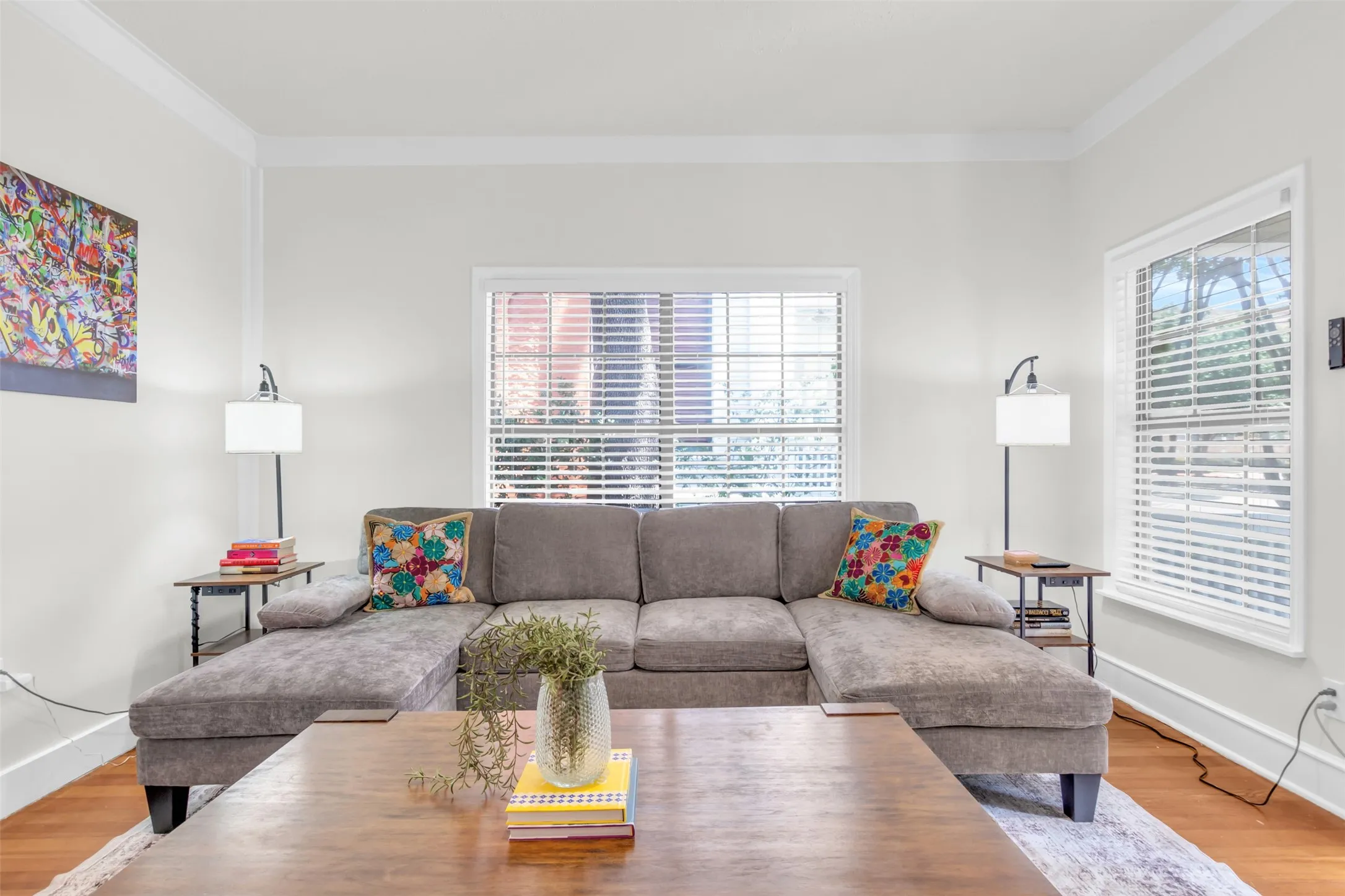 Living area featuring hardwood flooring and crown molding