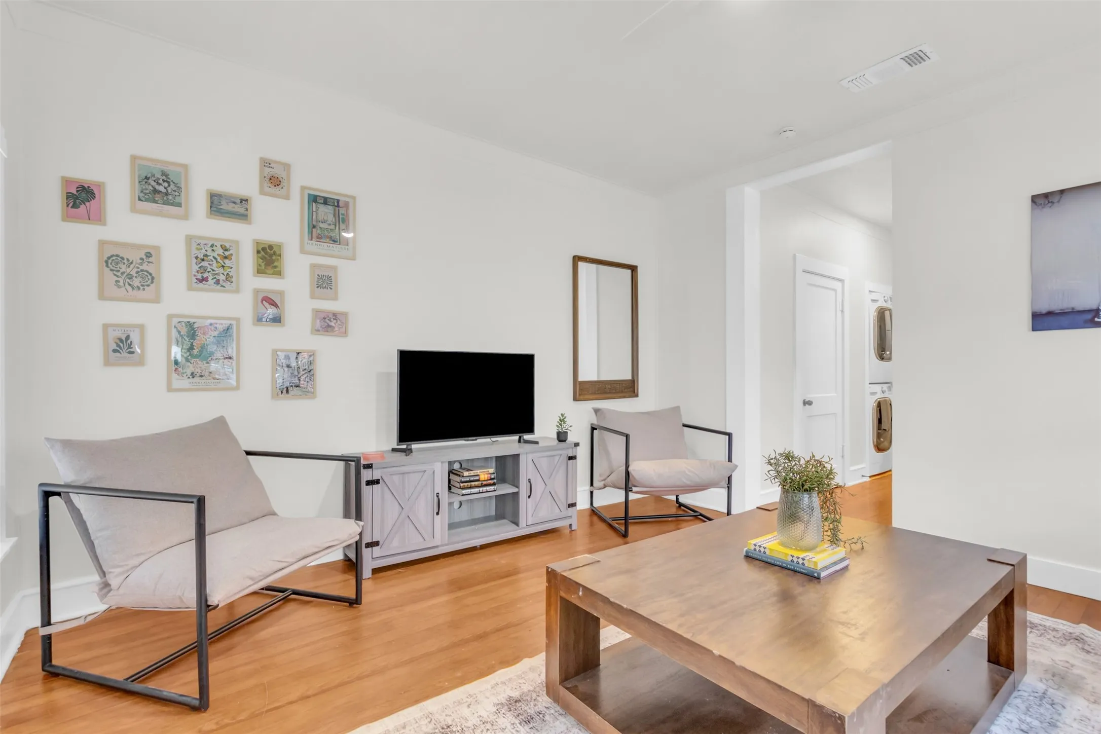 Open-concept living space with wood-finish flooring