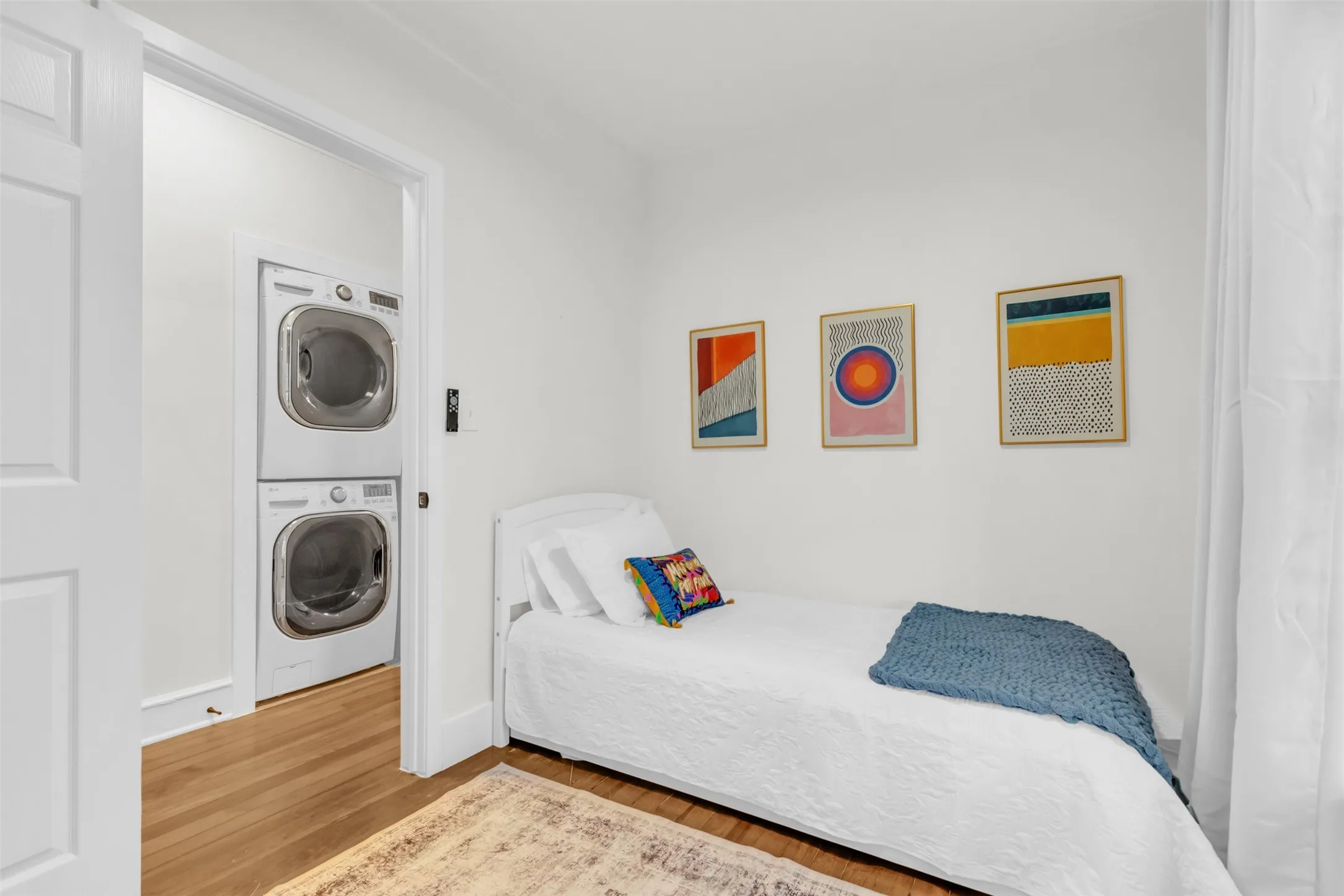Compact laundry area featuring stacked front-load washer and dryer units