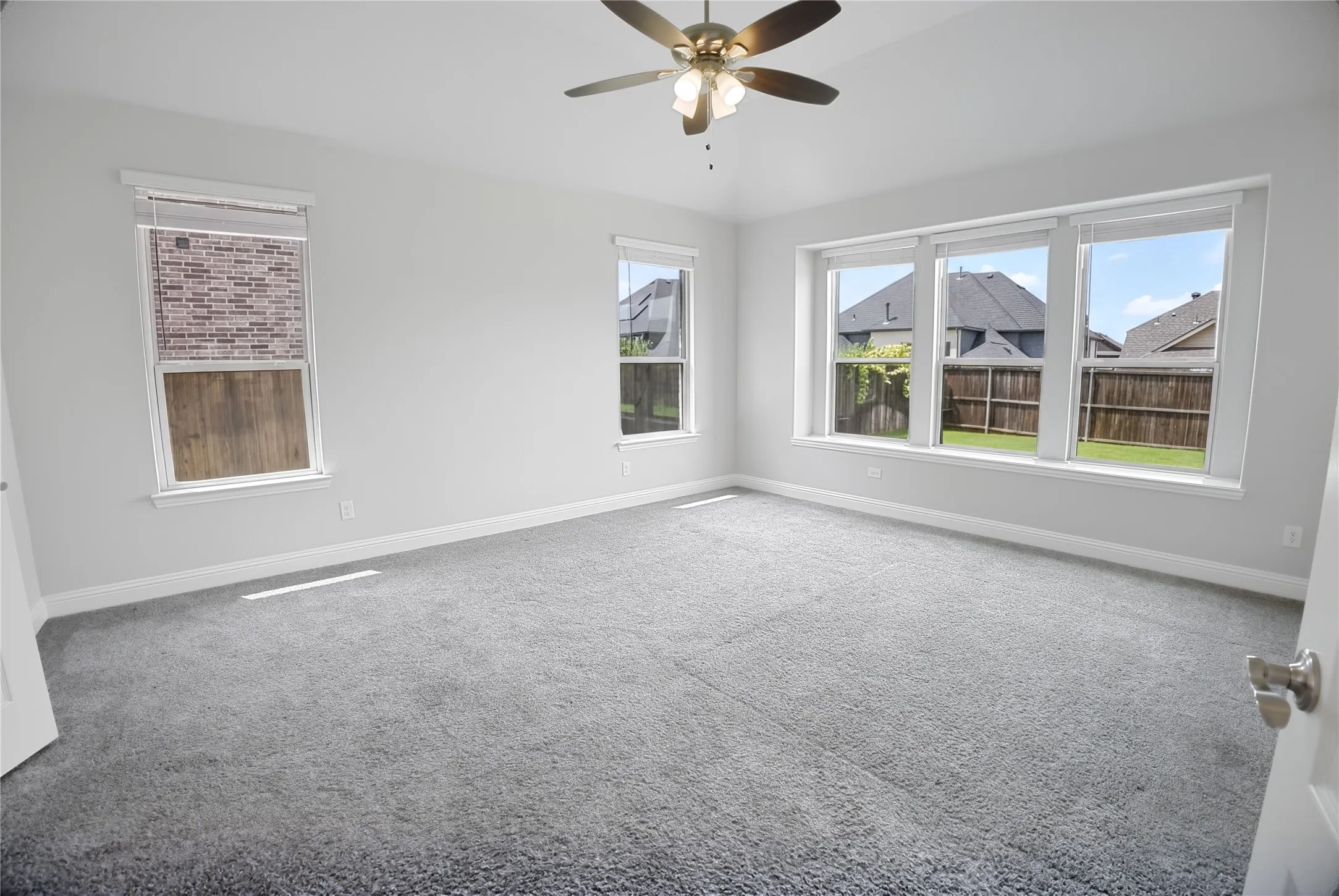 Spacious interior with neutral gray carpeting and light-colored walls