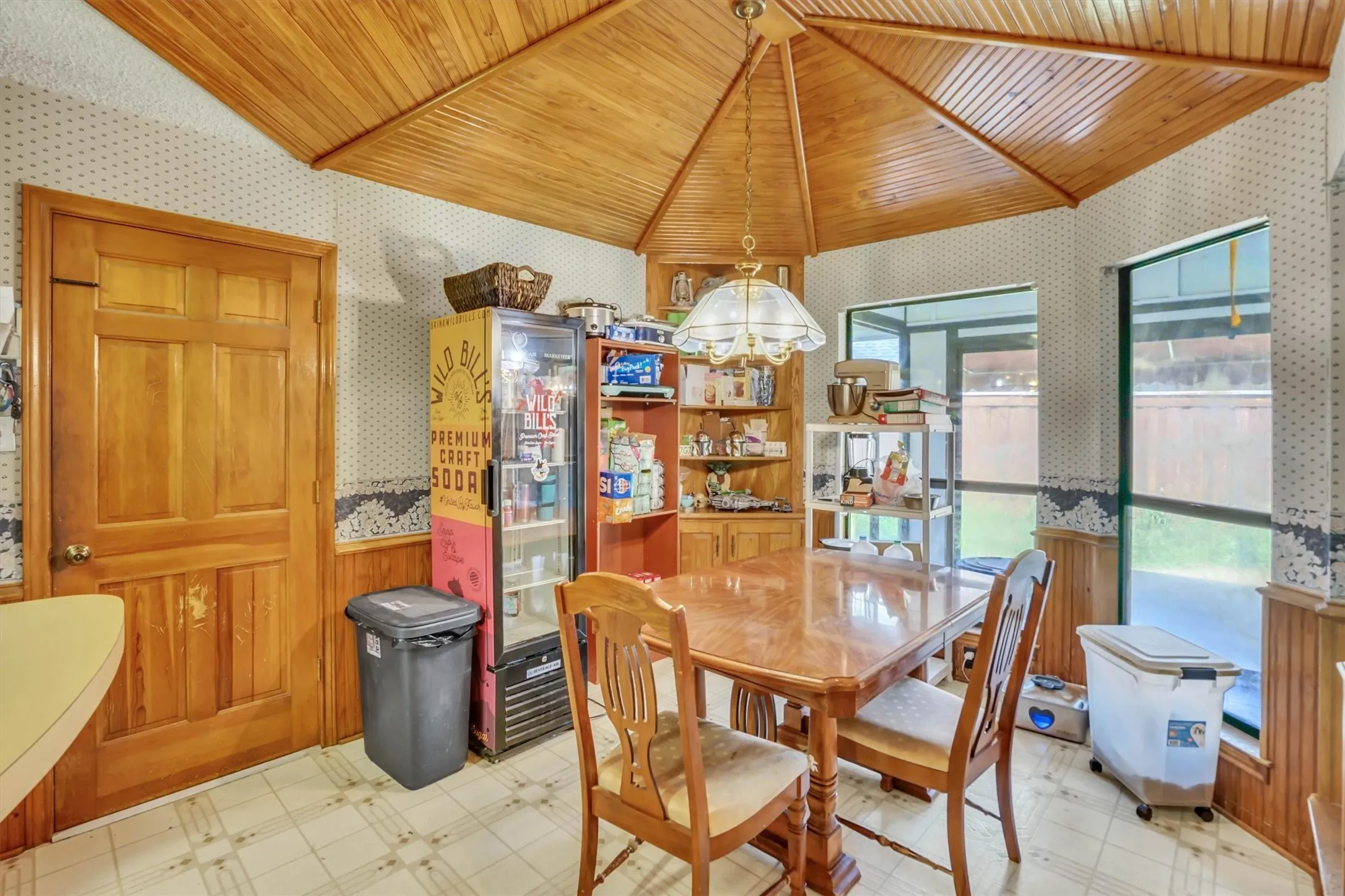 Wood-paneled ceiling with a central pendant light fixture