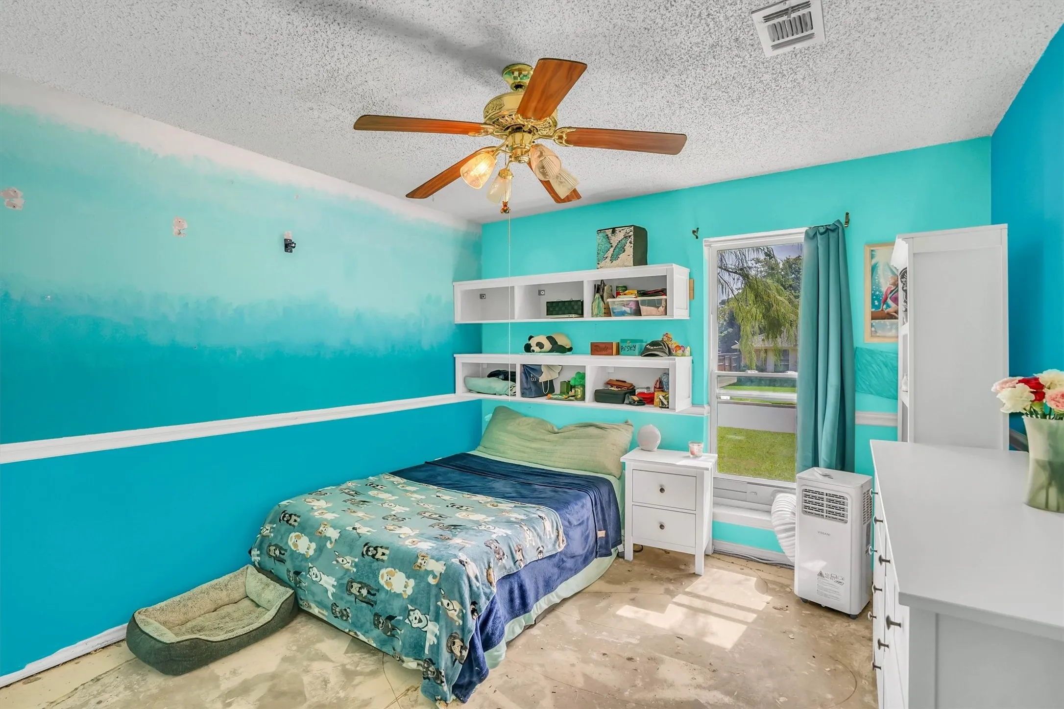 Room featuring a window with exterior views, white trim, and a ceiling fan